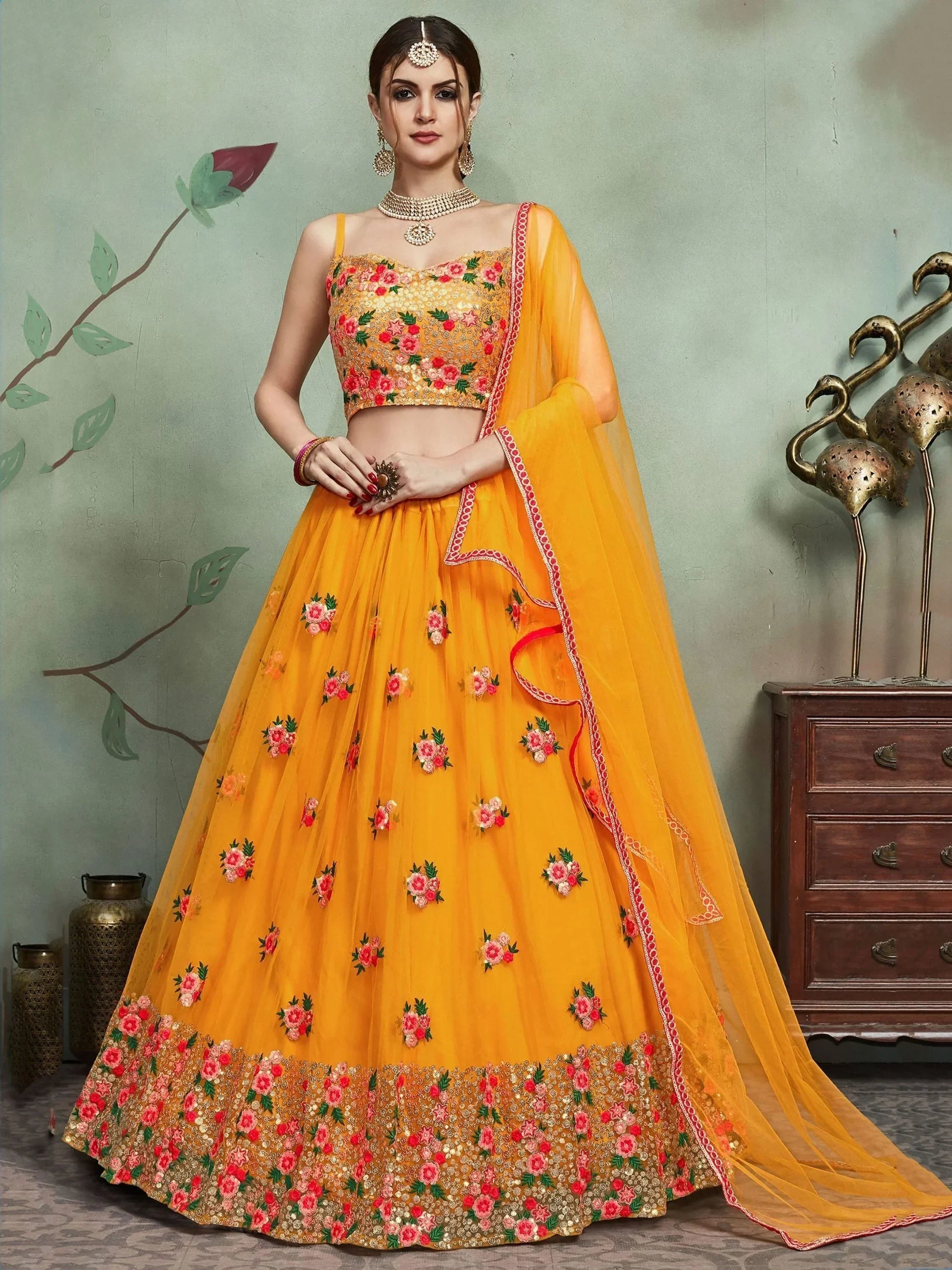 Yellow floral embroidered lehenga choli with matching dupatta, perfect for Indian weddings and festive occasions.