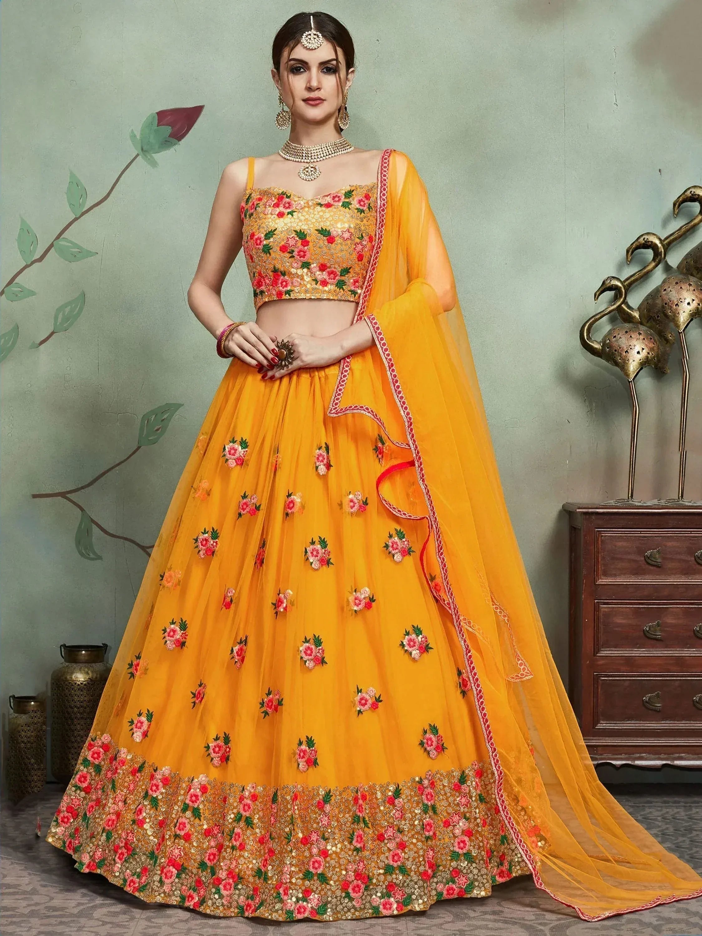 Yellow floral embroidered lehenga choli with matching dupatta, perfect for Indian weddings and festive occasions.