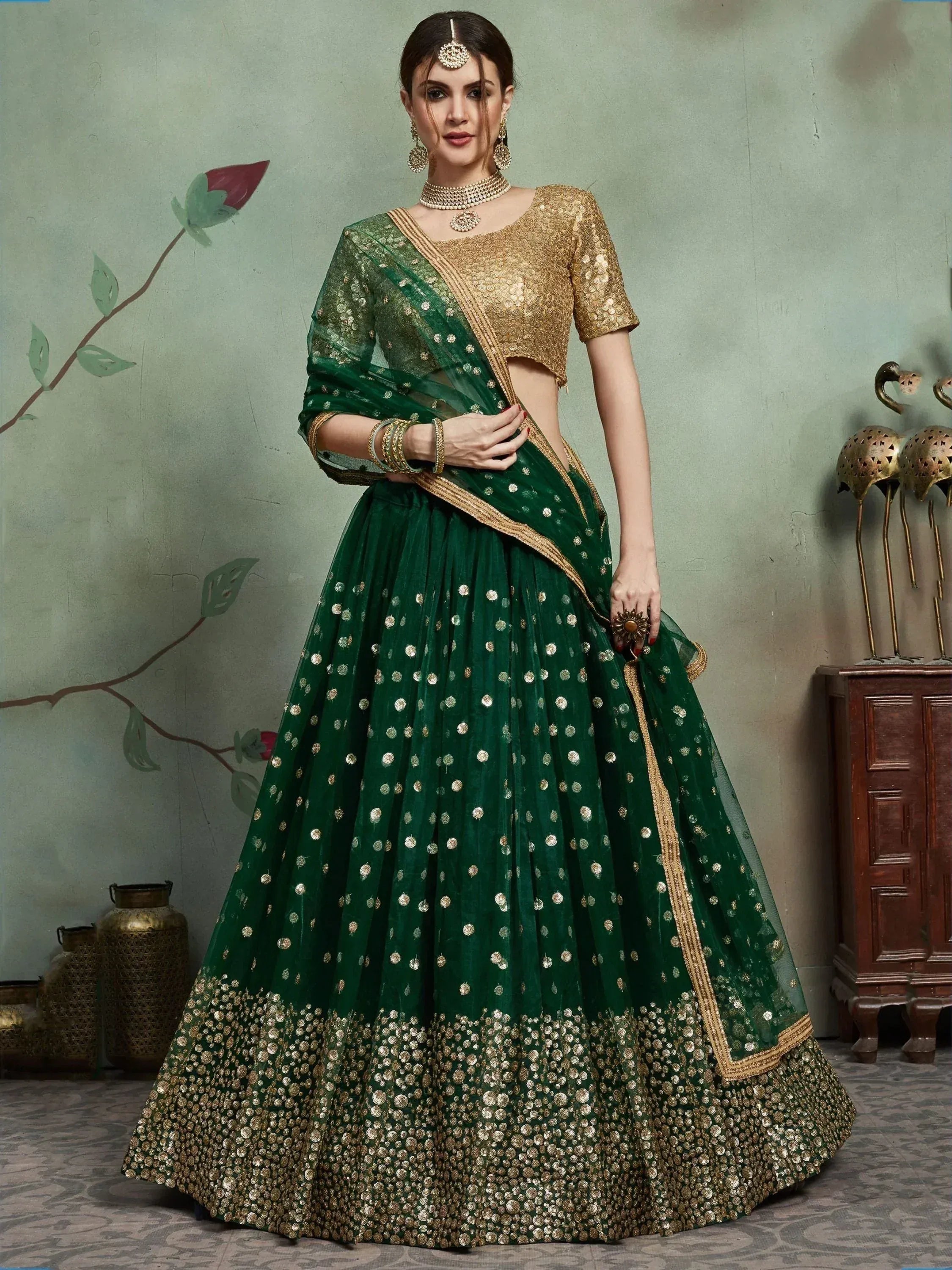 Emerald green lehenga choli with gold sequin work, perfect for Indian weddings and festive occasions.