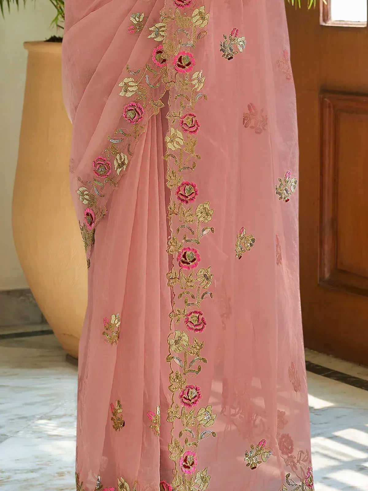 Pink floral embroidered saree with gold detailing, perfect for ethnic occasions
