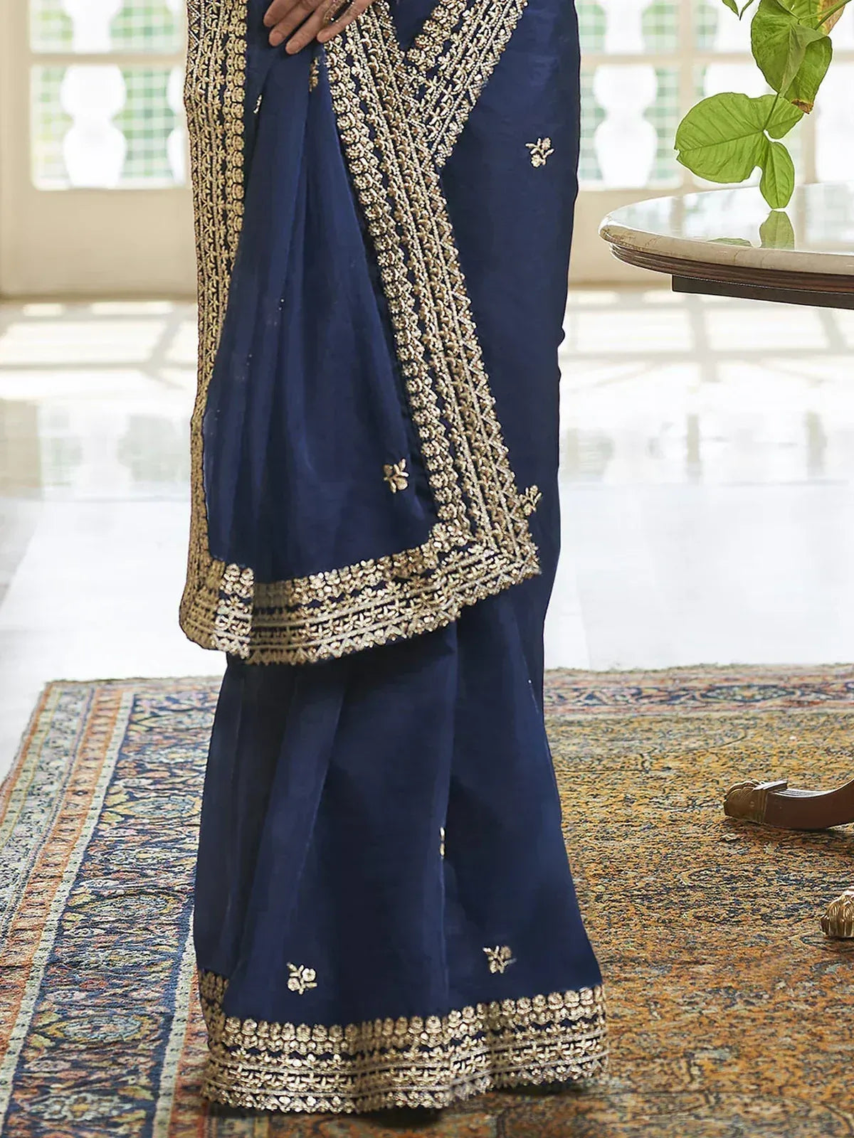 Navy blue ethnic saree with gold embroidery, perfect for Indian weddings and festive occasions.