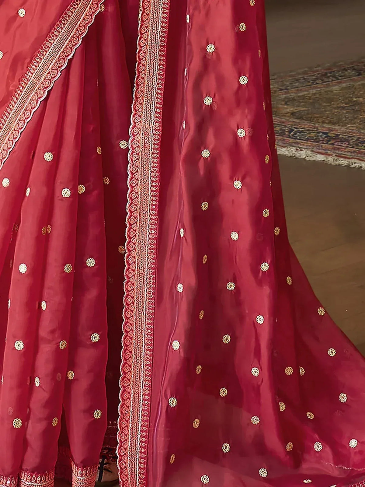 Red ethnic lehenga choli with gold embroidery and lace border, perfect for Indian weddings and festivals