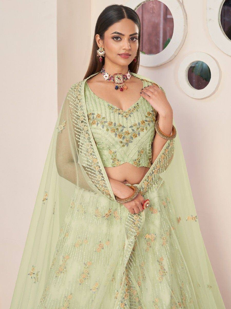 Mint green embroidered lehenga choli with floral detailing and sheer dupatta, perfect for Indian ethnic wear occasions.