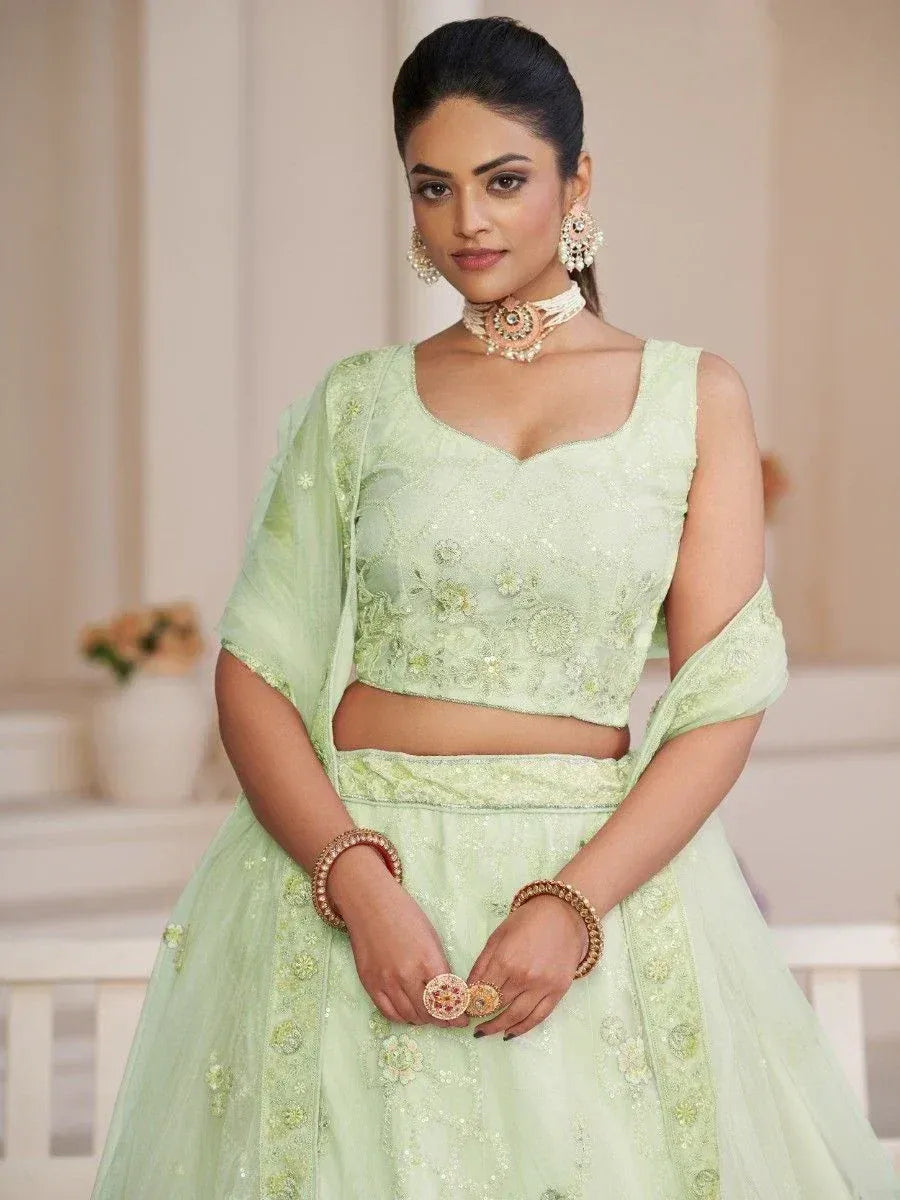 Mint green embroidered lehenga choli with floral detailing, perfect for Indian ethnic wear occasions.