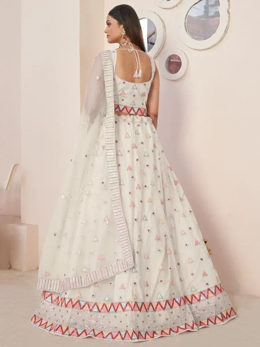 White lehenga choli with colorful triangle embroidery and sheer dupatta, perfect for Indian ethnic occasions