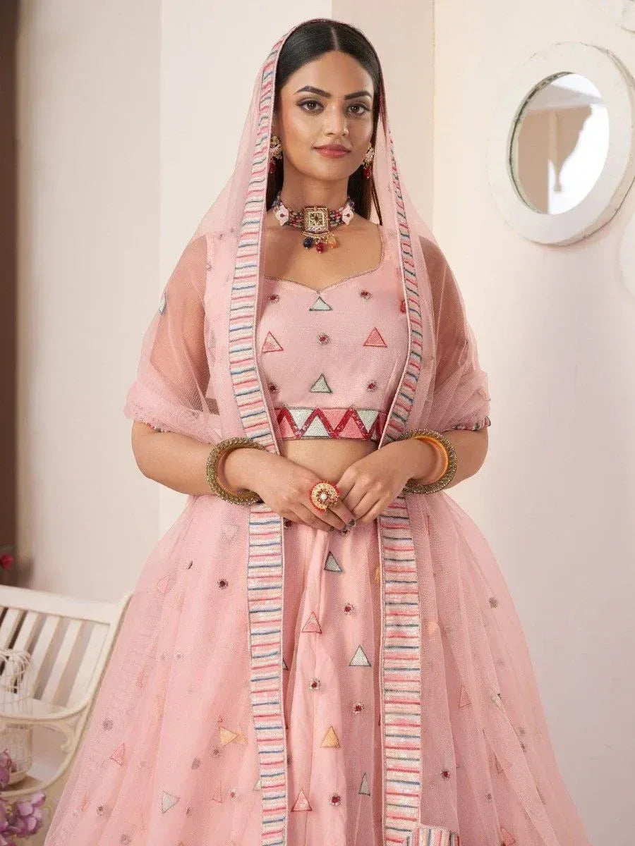 Pink embroidered lehenga choli with geometric patterns and matching dupatta, ideal for Indian ethnic occasions