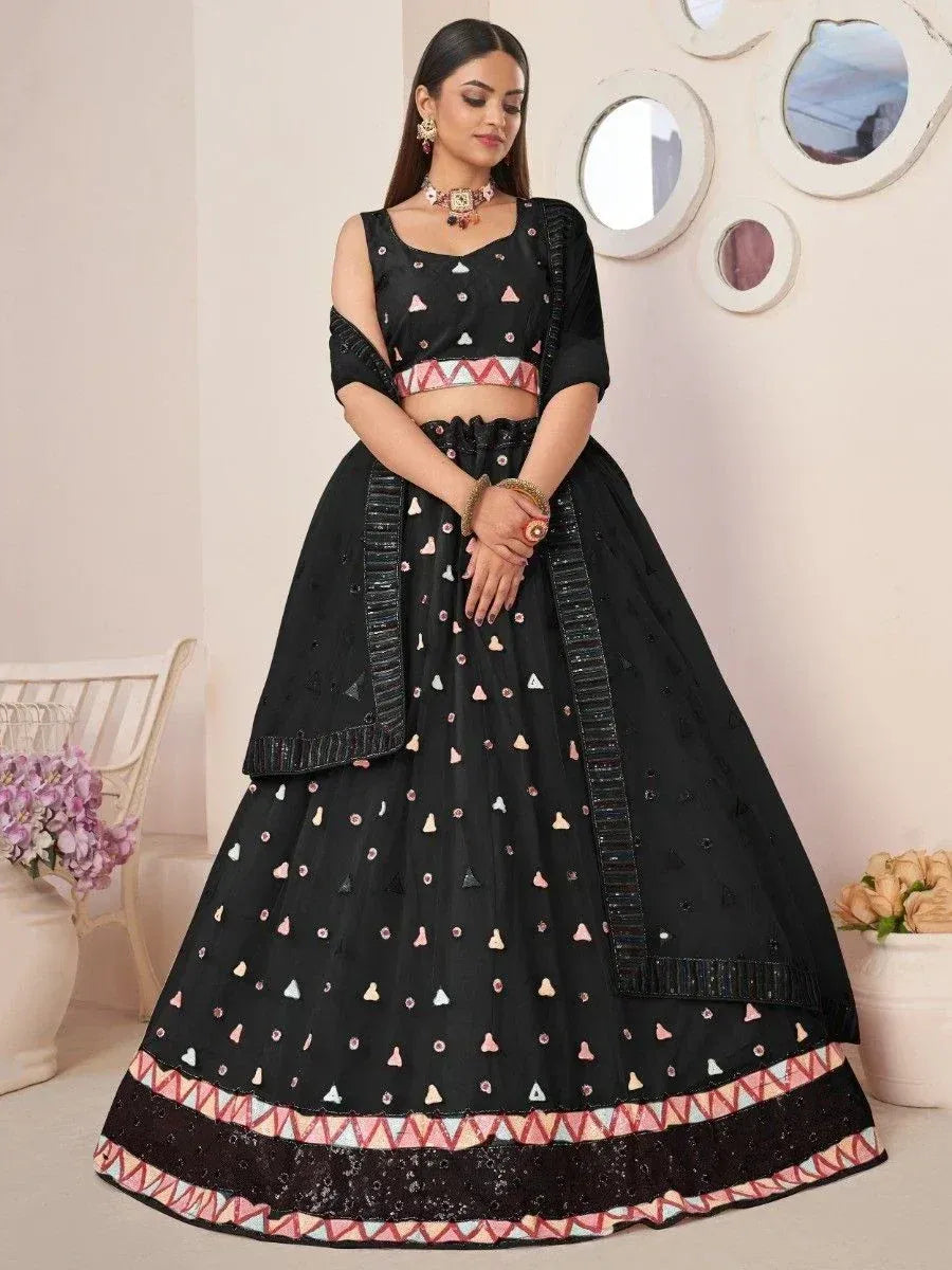 Black lehenga choli with geometric embroidery and pink border, perfect for Indian ethnic occasions
