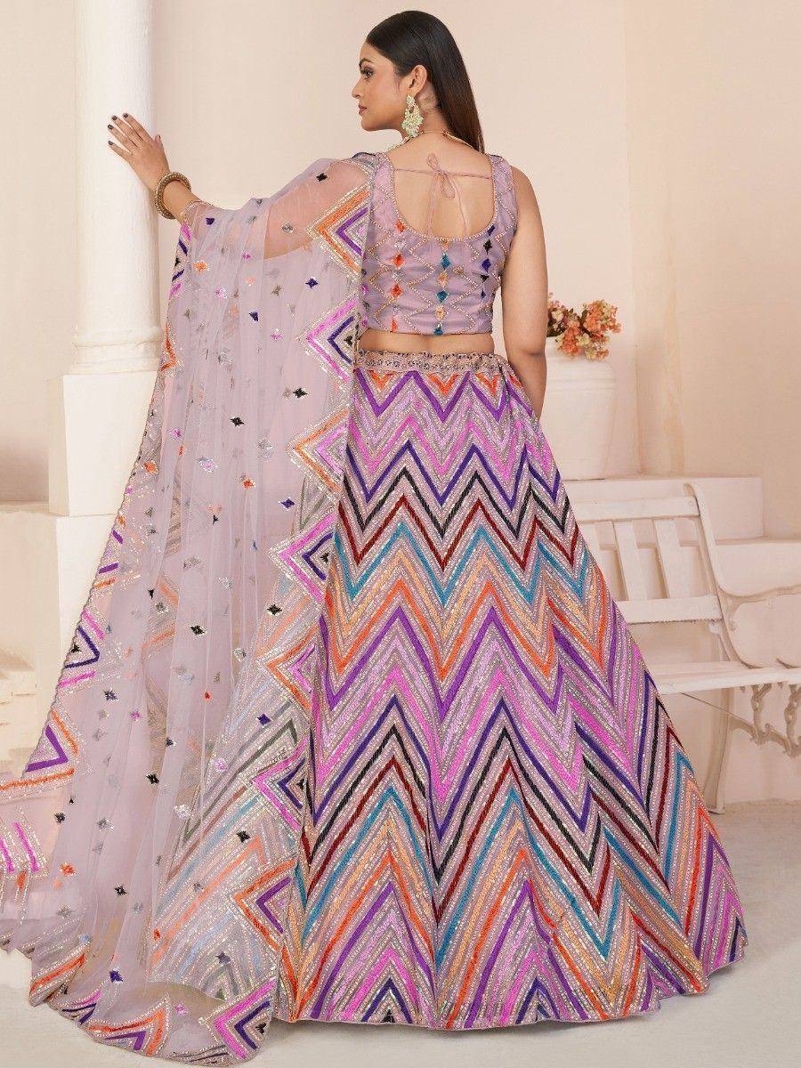 Pastel lehenga choli with colorful zigzag embroidery and sheer dupatta, perfect for Indian ethnic occasions