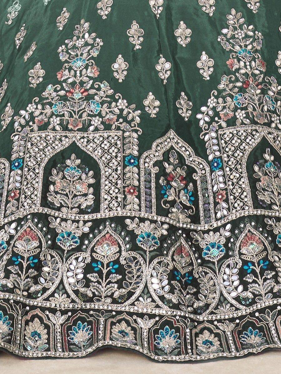 Emerald green lehenga with intricate floral embroidery and mirror work, perfect for Indian ethnic wear.