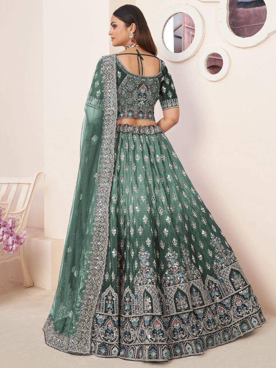 Emerald green designer lehenga choli with heavy embroidery and dupatta, perfect for weddings and festivals.