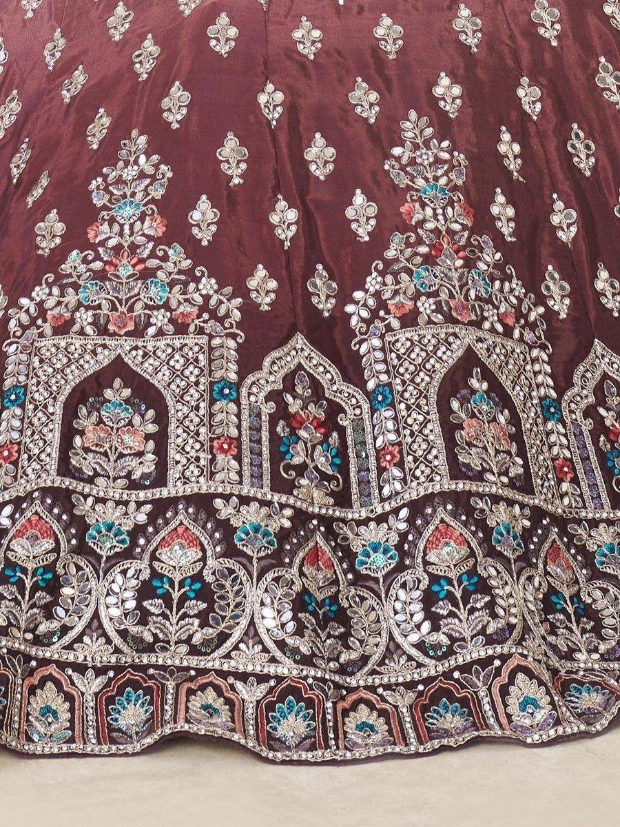 Maroon lehenga with intricate floral embroidery and mirror work, perfect for Indian weddings and festive occasions.