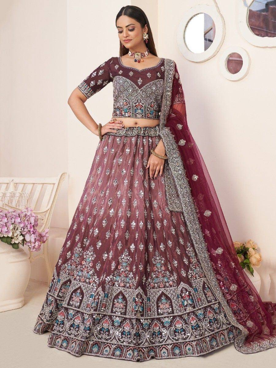 Maroon embroidered lehenga choli with heavy embellishments, perfect for Indian weddings and festive occasions