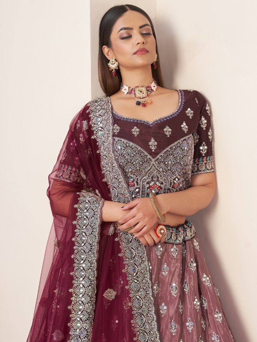 Elegant maroon lehenga choli with heavy silver embroidery and matching dupatta, perfect for Indian weddings.