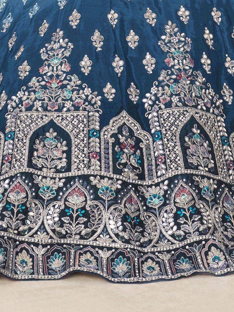 Blue velvet lehenga with intricate floral embroidery and mirror work, perfect for Indian ethnic wear.