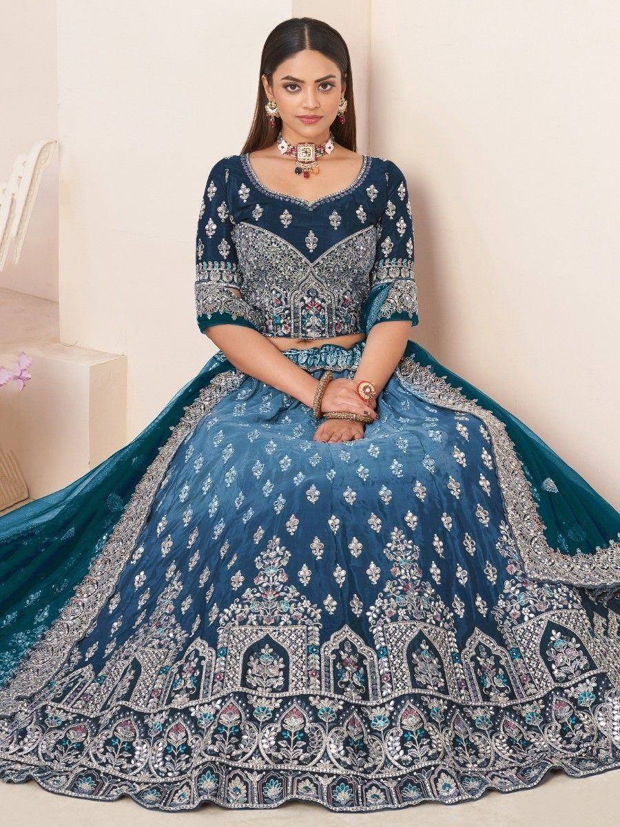 Blue embroidered lehenga choli with intricate silver work, perfect for Indian weddings and festive occasions