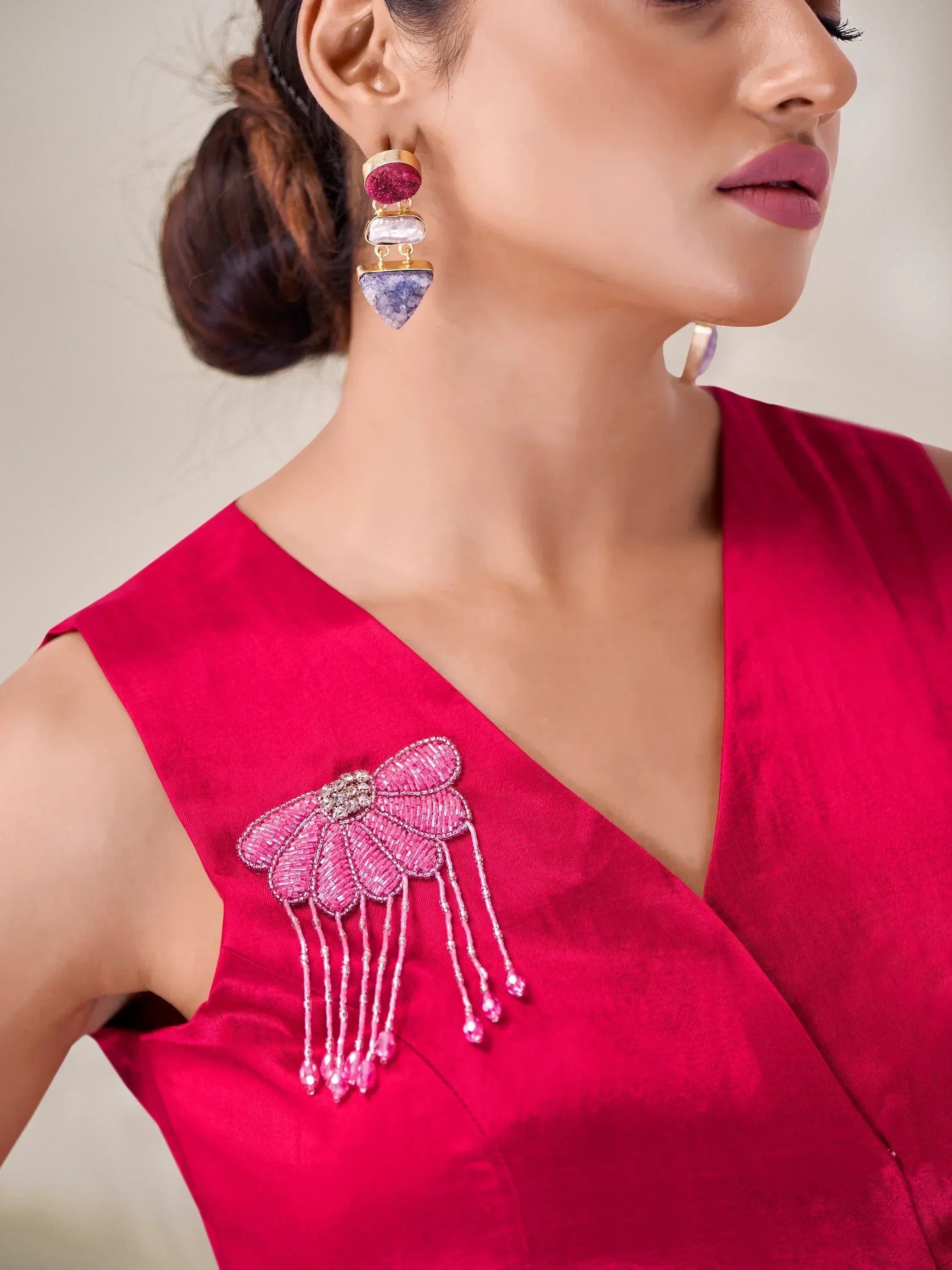 Red ethnic gown with beaded floral embellishment and statement earrings for Indian wear
