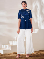Woman wearing navy blue embroidered kurti top with white palazzo pants from Ethnic Plus