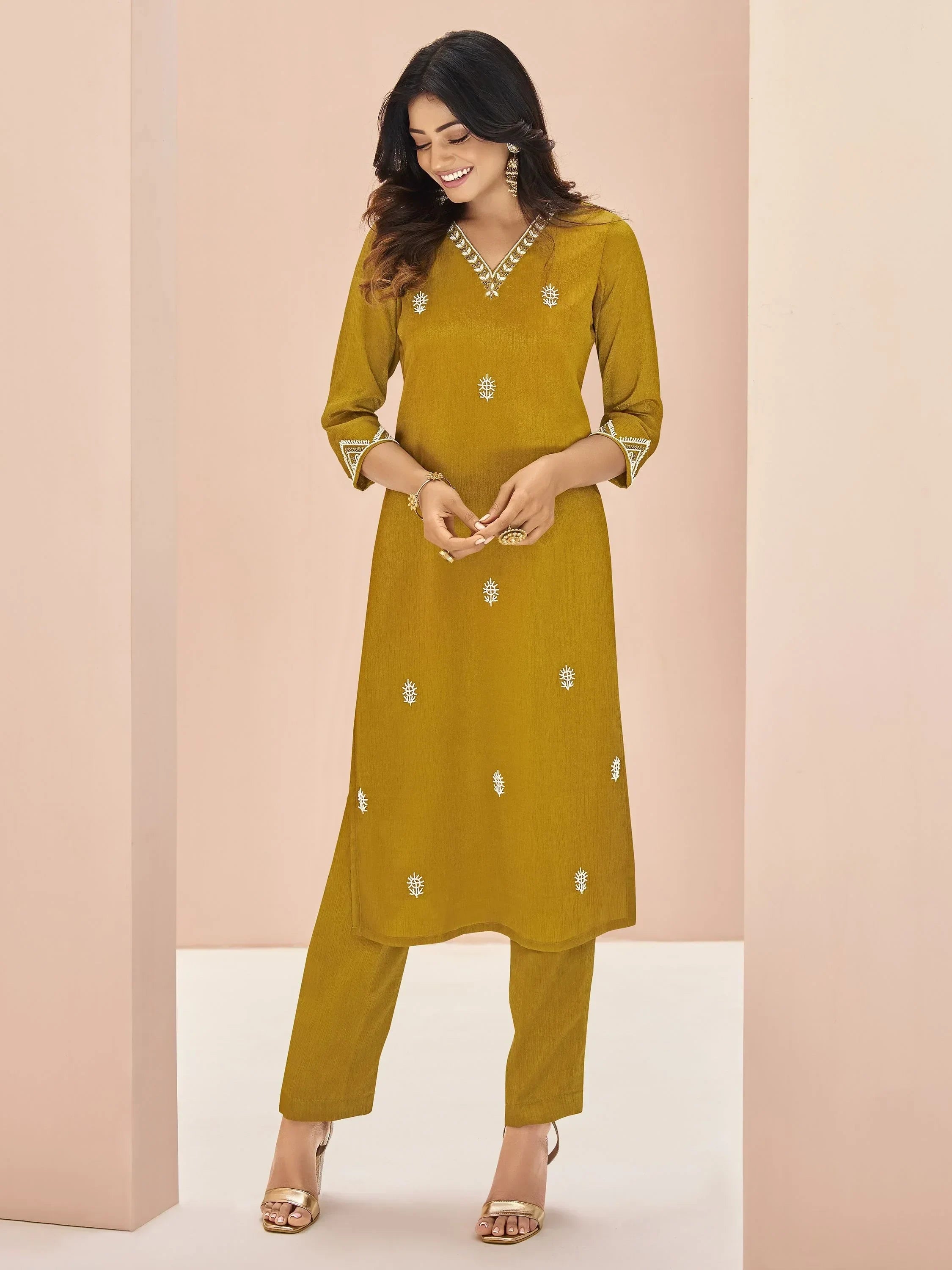 Woman wearing mustard yellow embroidered straight cut salwar kameez with matching pants