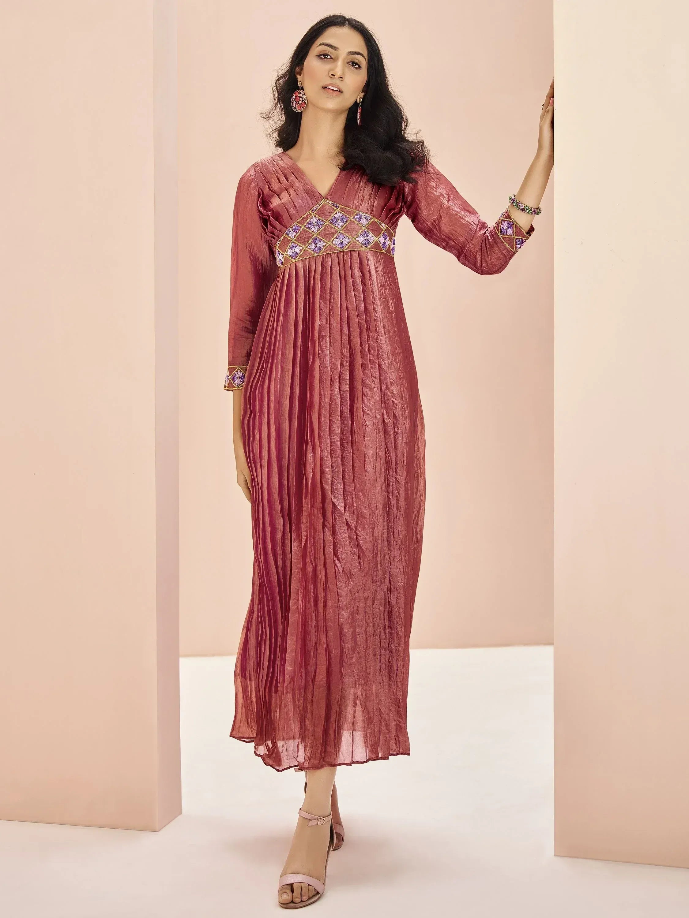 Elegant maroon ethnic gown with purple gold embroidery, perfect for Indian festive occasions