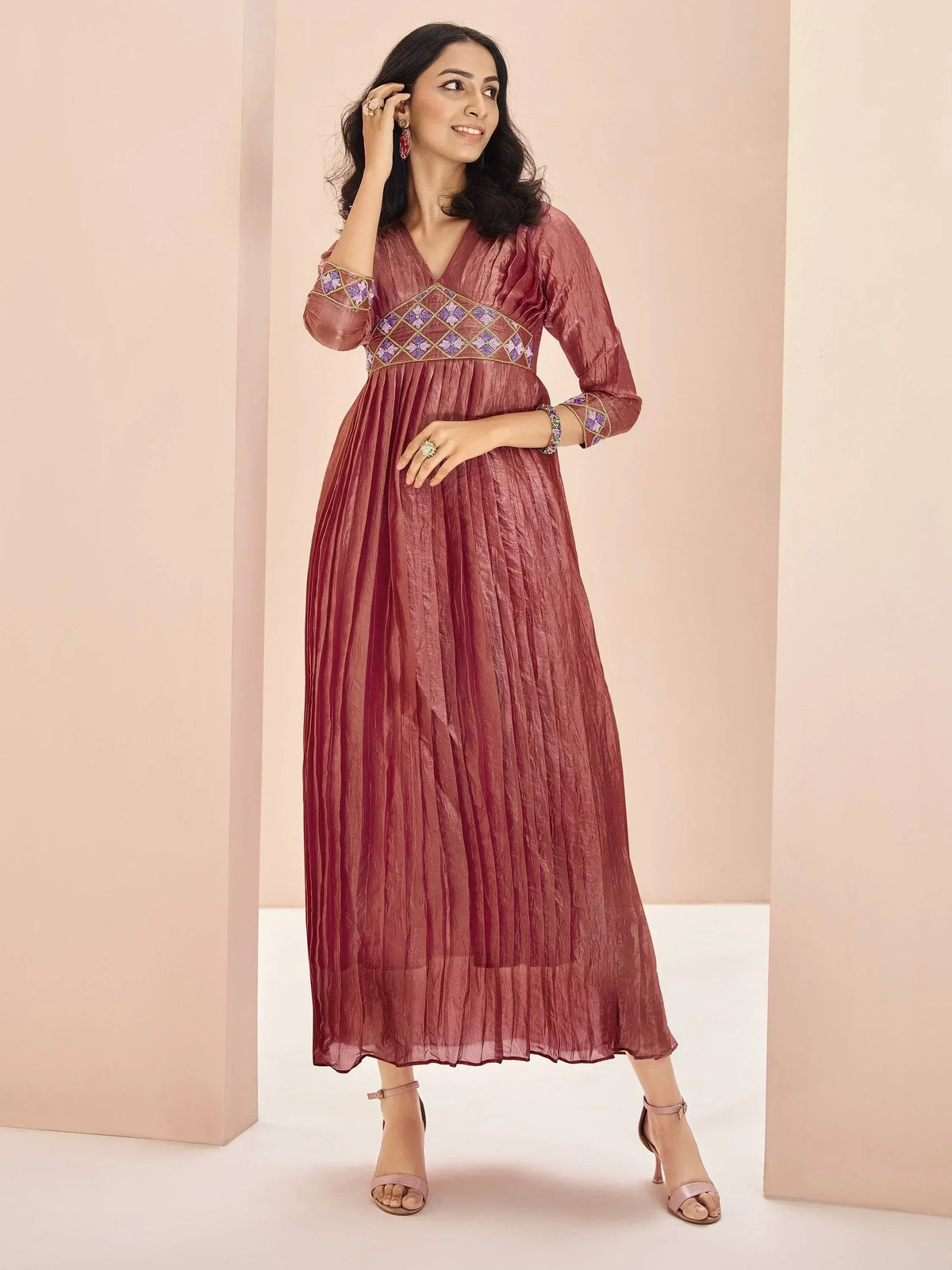 Elegant maroon ethnic gown with purple floral embroidery, perfect for Indian occasions and festive wear.