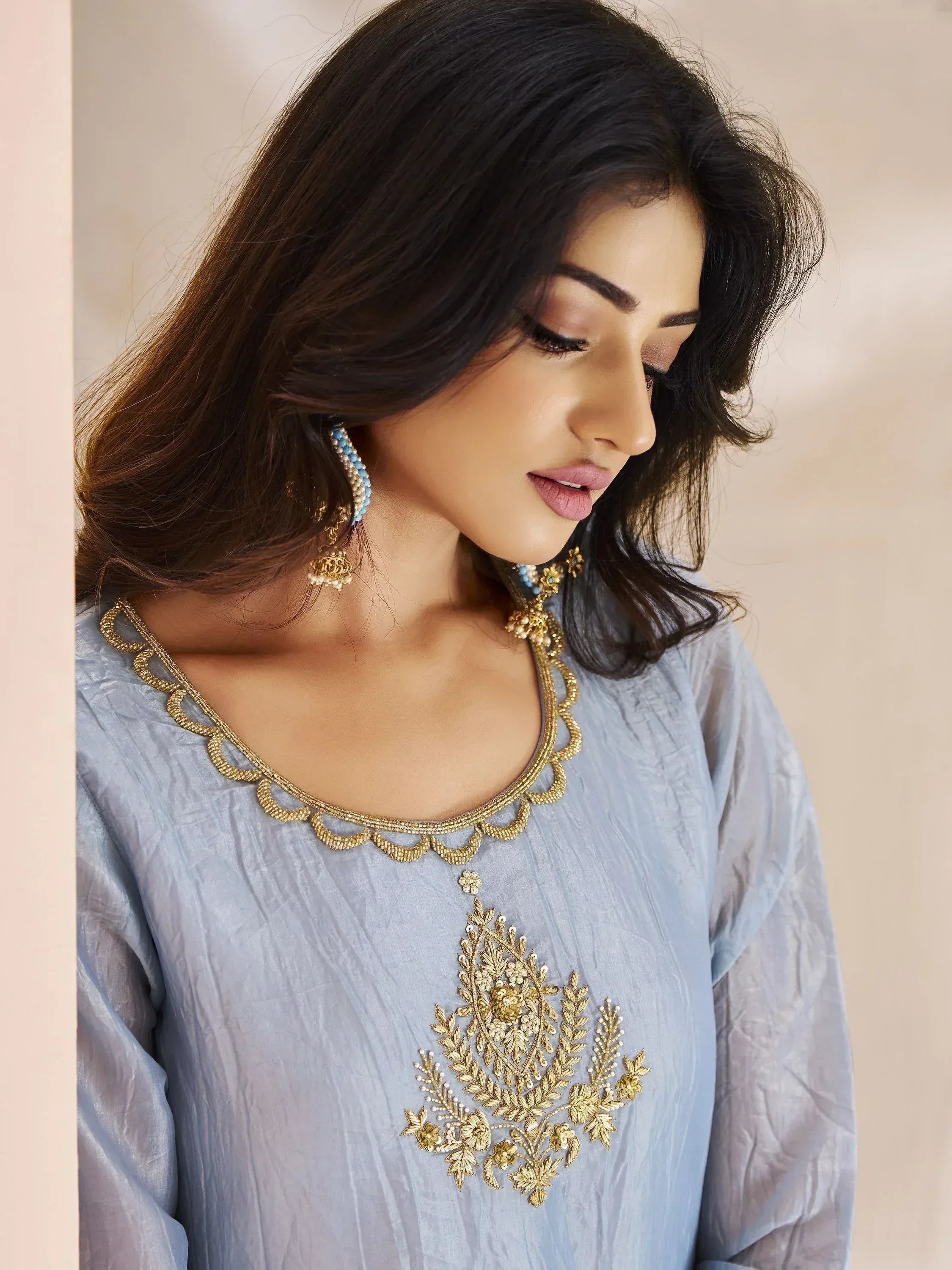 Light blue ethnic kurta with gold embroidery and matching jewelry for Indian wear
