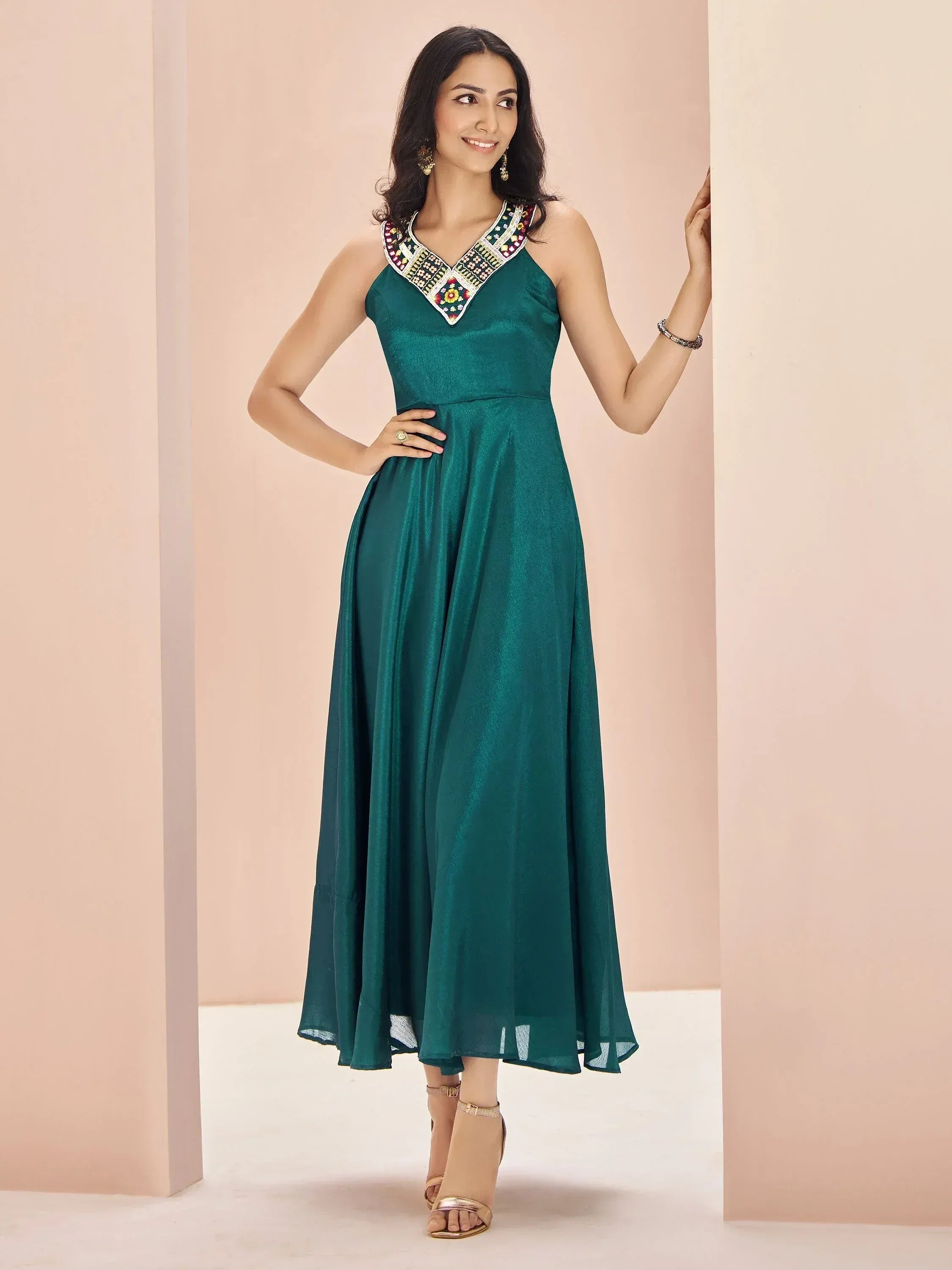 Emerald green ethnic gown with embroidered neckline, perfect for Indian occasions and parties.