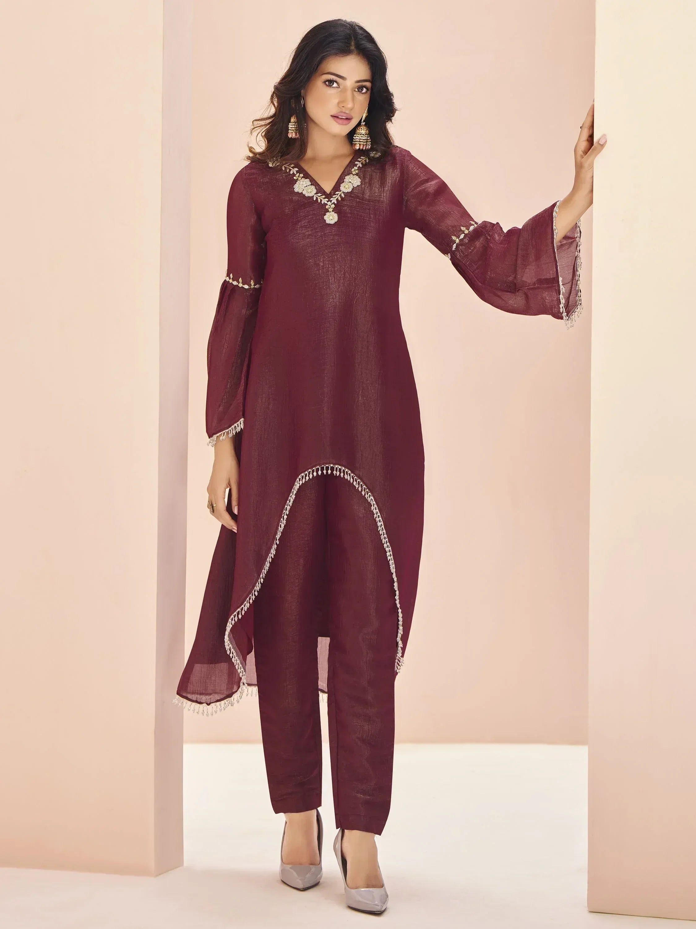 Maroon ethnic kurta with floral embroidery and bell sleeves, paired with matching pants for Indian wear