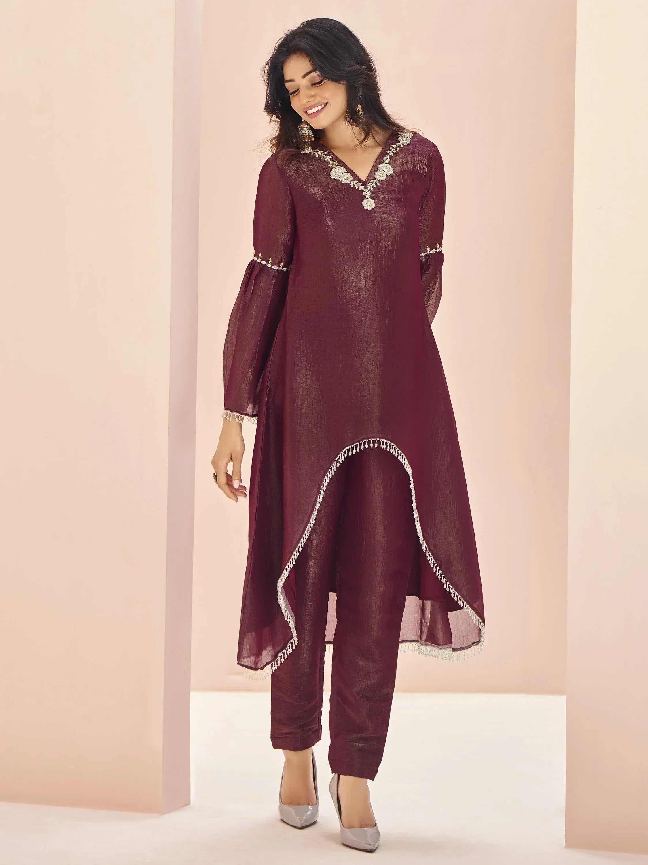 Maroon ethnic kurta with floral embroidery and high-low hem, paired with matching pants for Indian wear