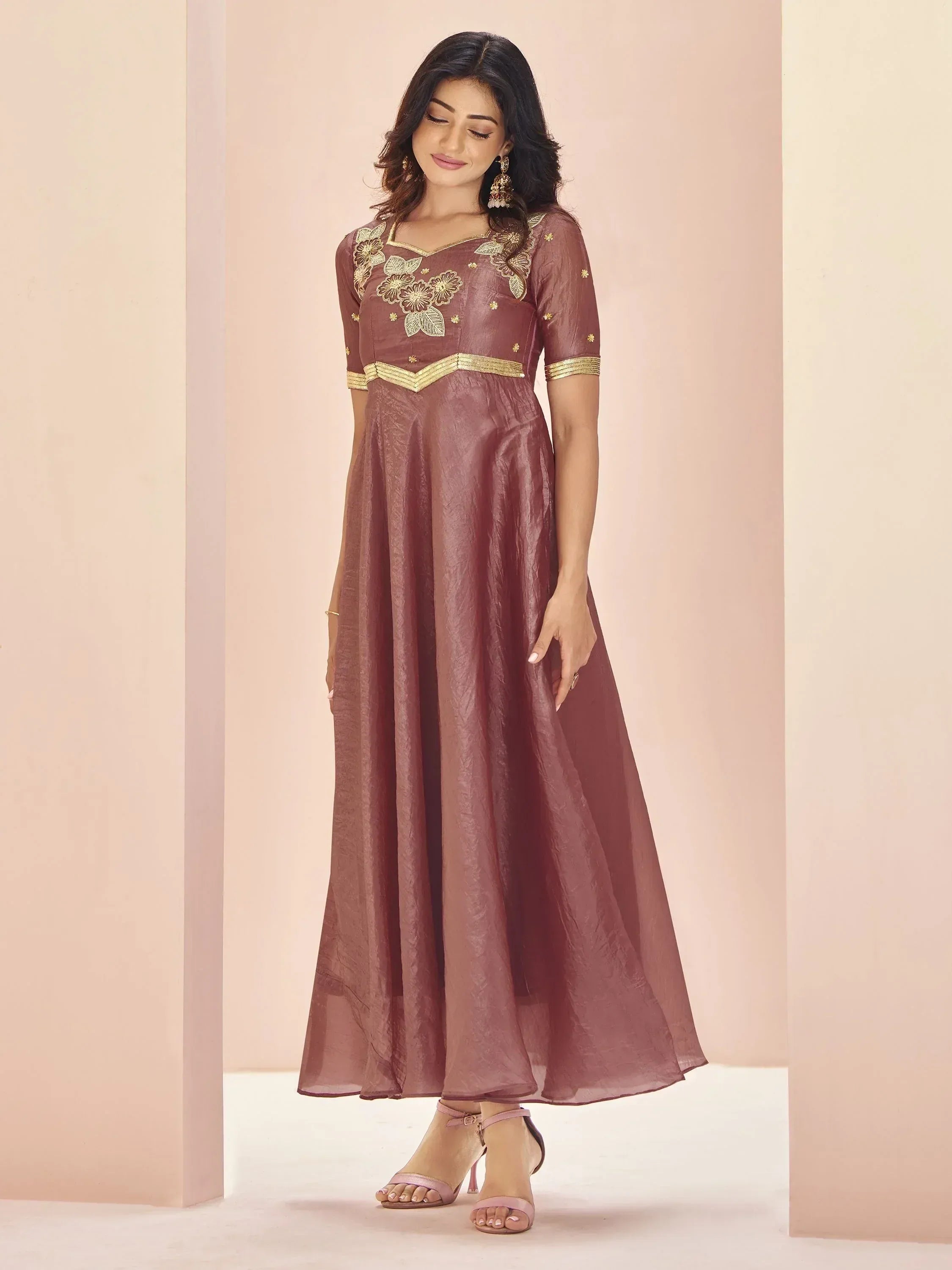 Mauve ethnic gown with gold floral embroidery and waistband, perfect for Indian occasions