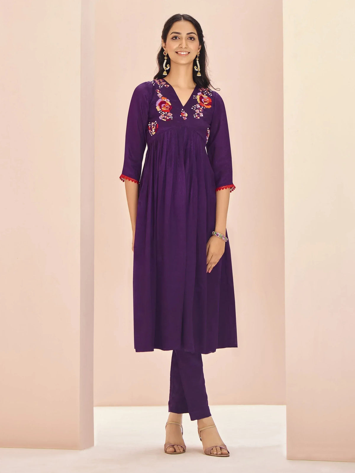 Purple embroidered kurta with floral design, paired with matching pants for ethnic wear