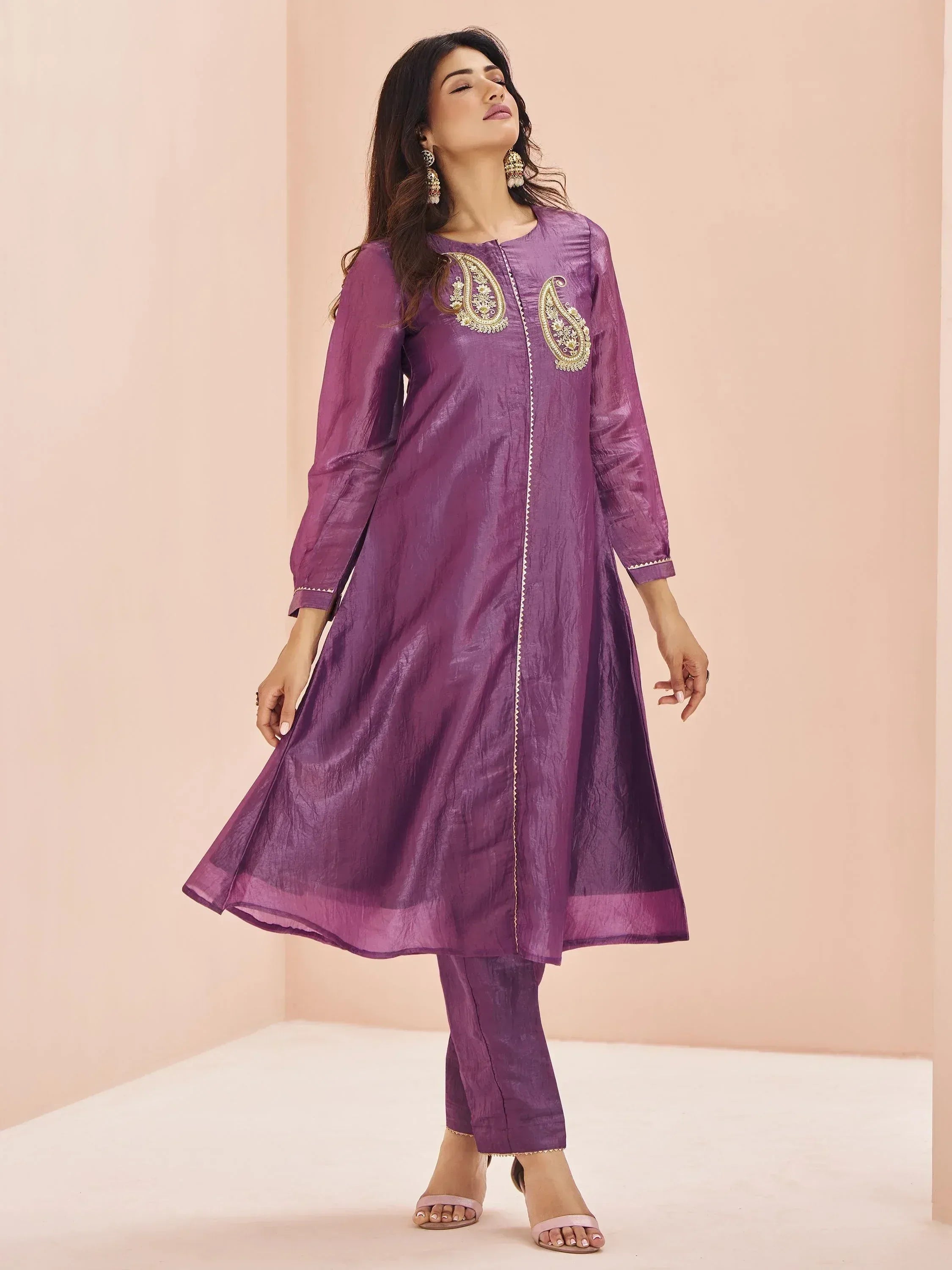 Purple ethnic kurta with gold paisley embroidery, matching pants, and statement earrings for festive occasions.