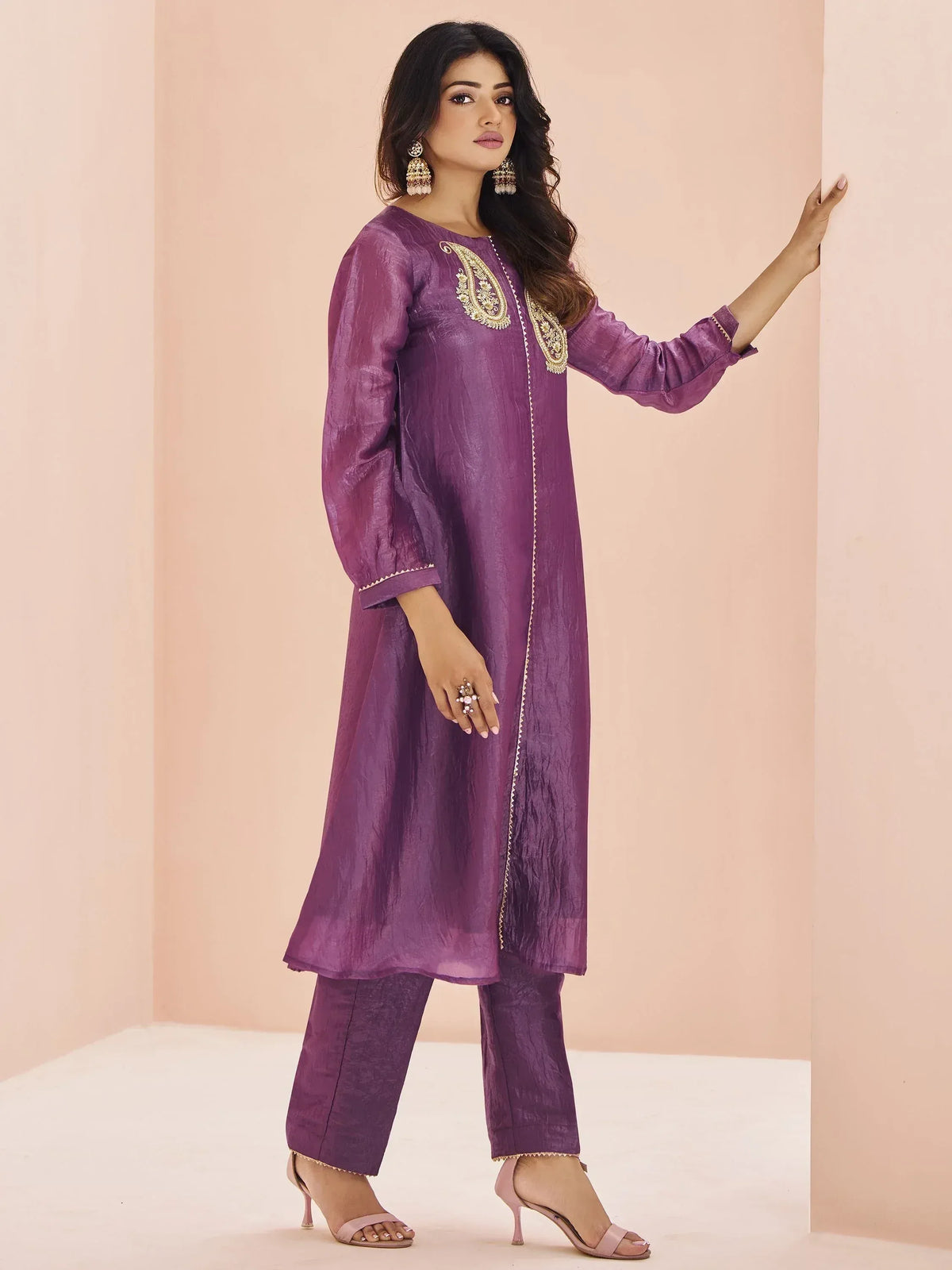 Purple ethnic kurta with gold embroidery and matching pants, styled with jhumka earrings for Indian wear