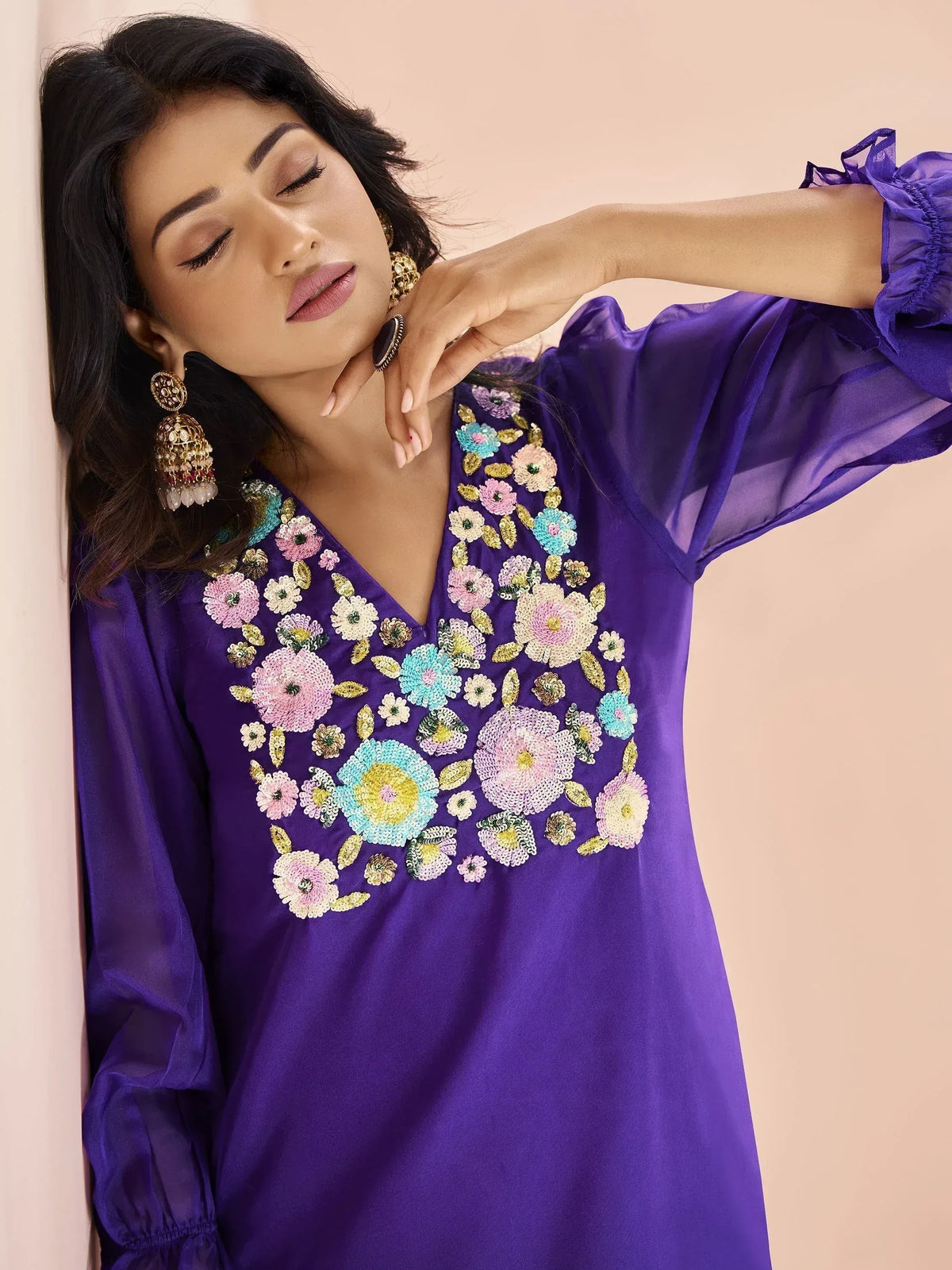 Purple ethnic gown with floral sequin embroidery and ruffled sleeves, styled with jhumka earrings