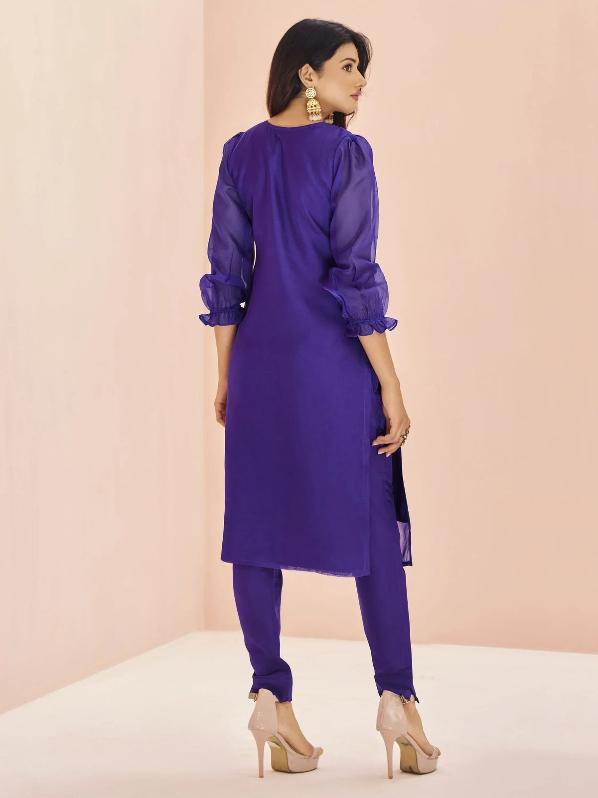 Purple ethnic kurta with sheer puff sleeves and matching pants, styled with gold earrings and heels