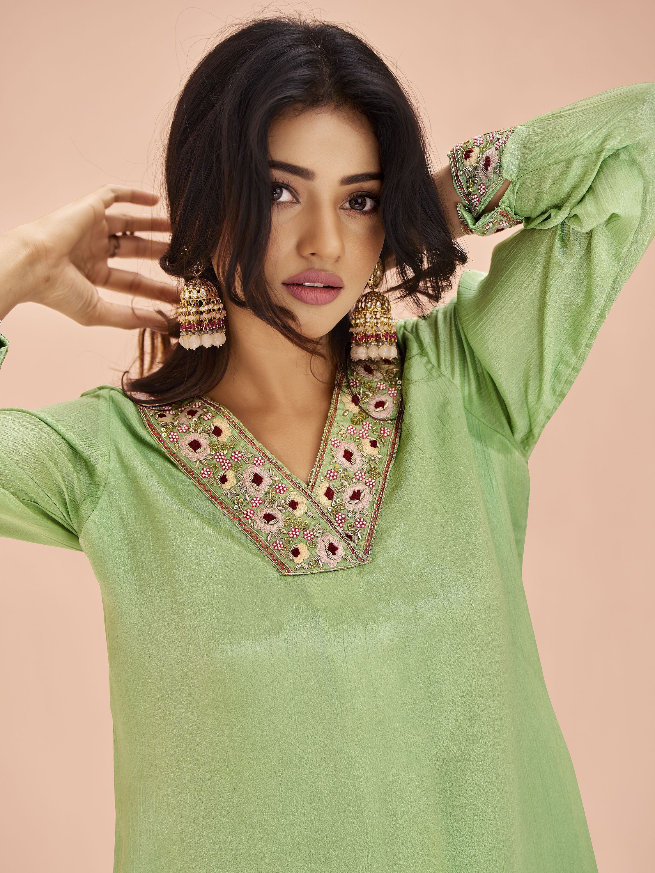 Woman in pastel green embroidered kurta with statement earrings, ethnic wear fashion