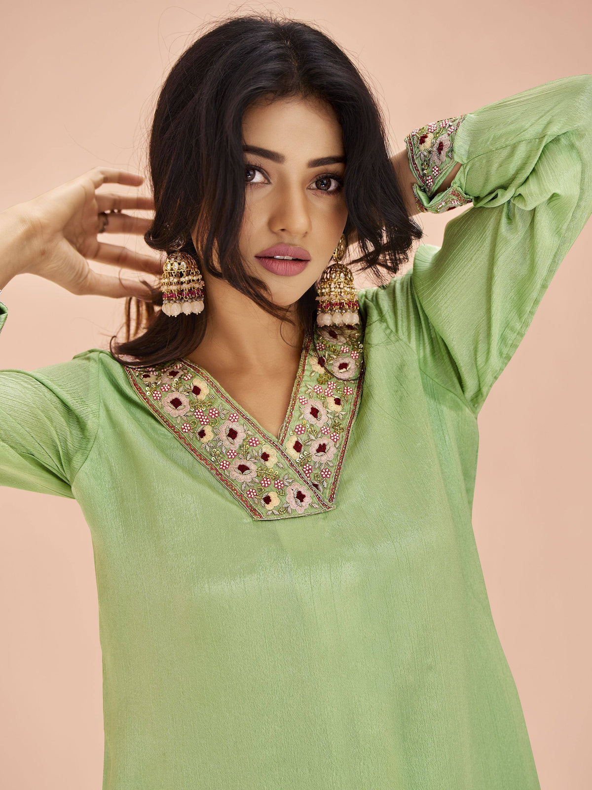 Green embroidered ethnic kurti with floral neckline and jhumka earrings, perfect for Indian wear
