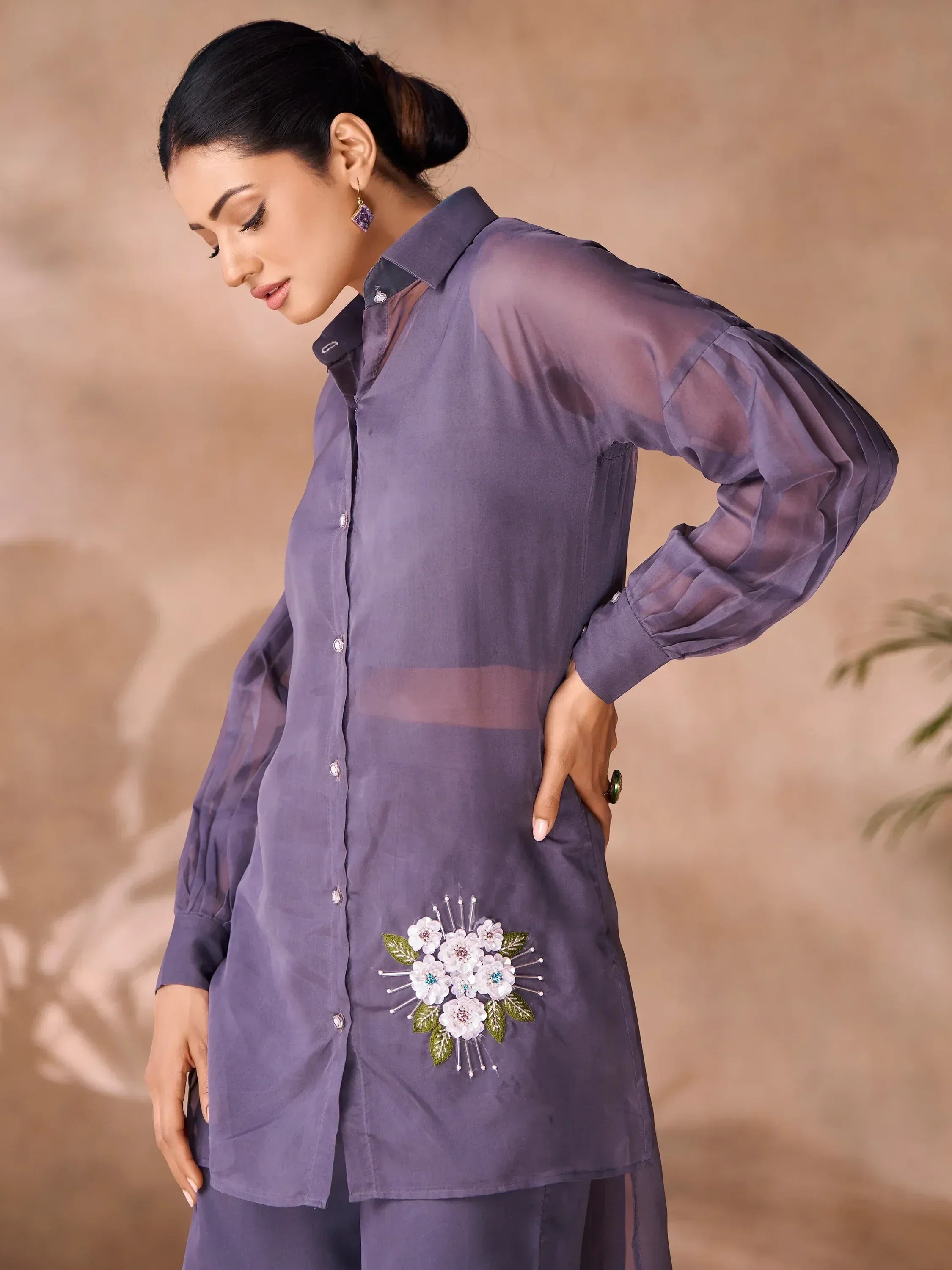 Purple ethnic kurti with floral embroidery and sheer sleeves, styled with matching pants for women.