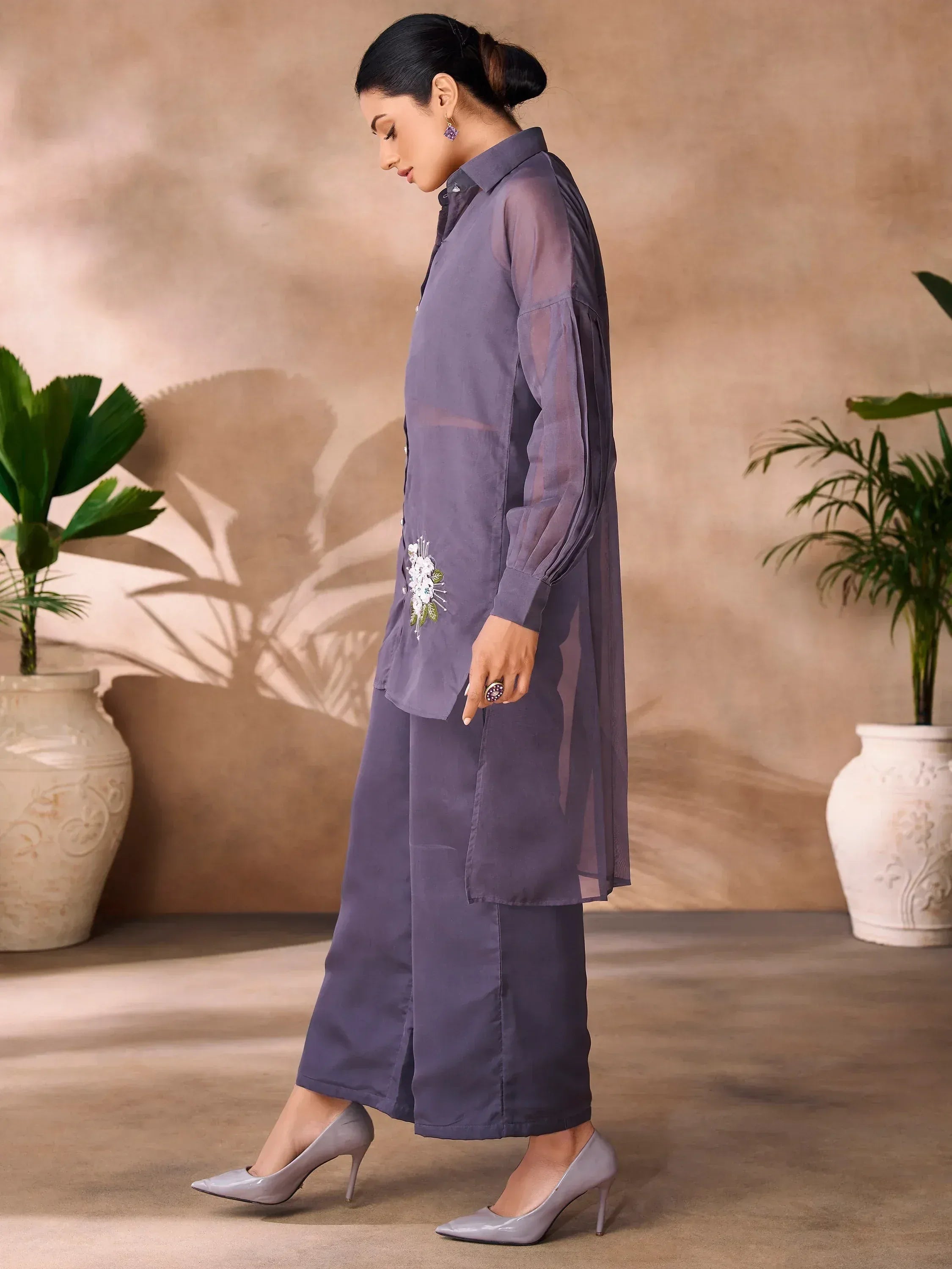 Purple ethnic kurta with floral embroidery, wide pants, and heels for modern Indian wear