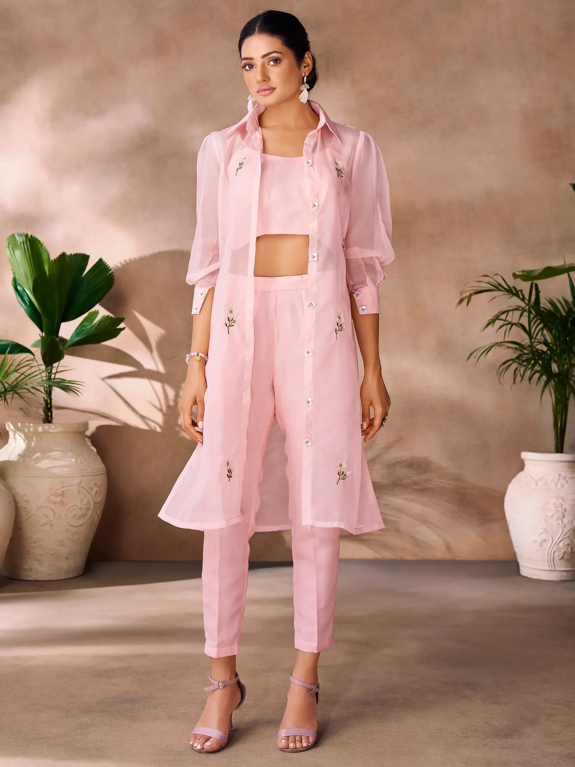 Pink embroidered kurta set with floral details, paired with matching pants and crop top for ethnic wear