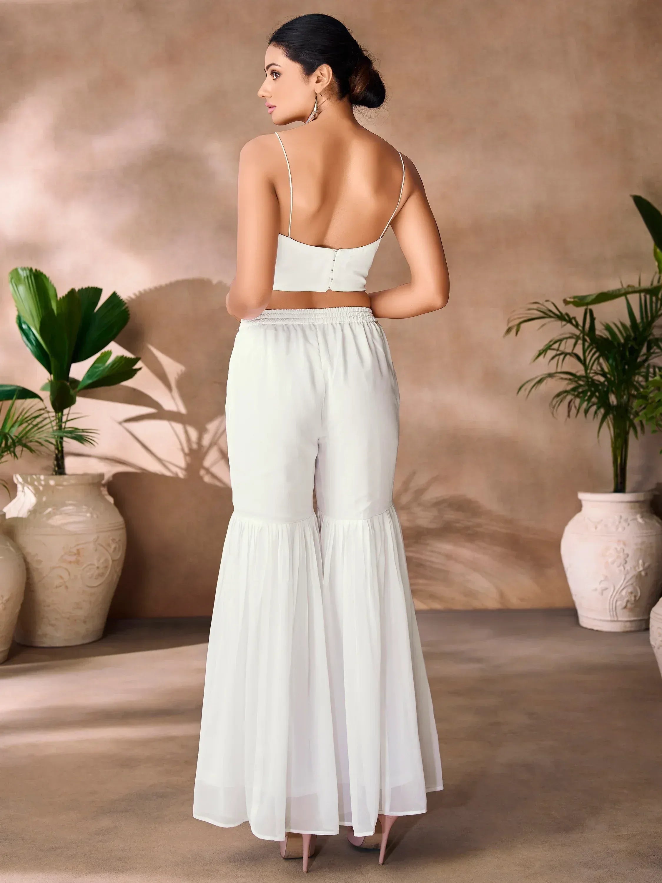 White ethnic palazzo set with spaghetti strap top, flared pants, perfect for Indian occasions