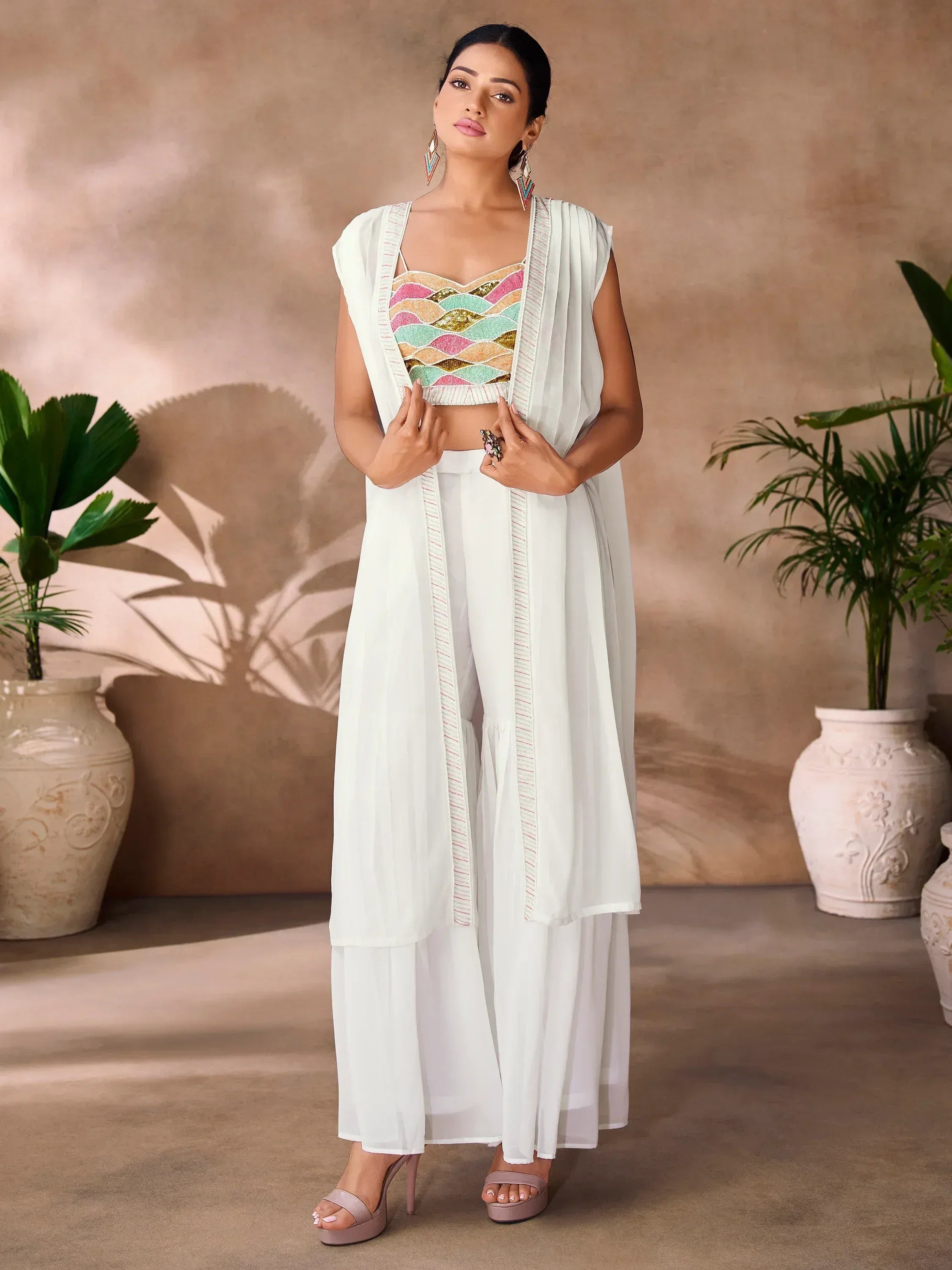 White ethnic palazzo set with colorful sequin crop top and draped jacket, perfect for Indian occasions