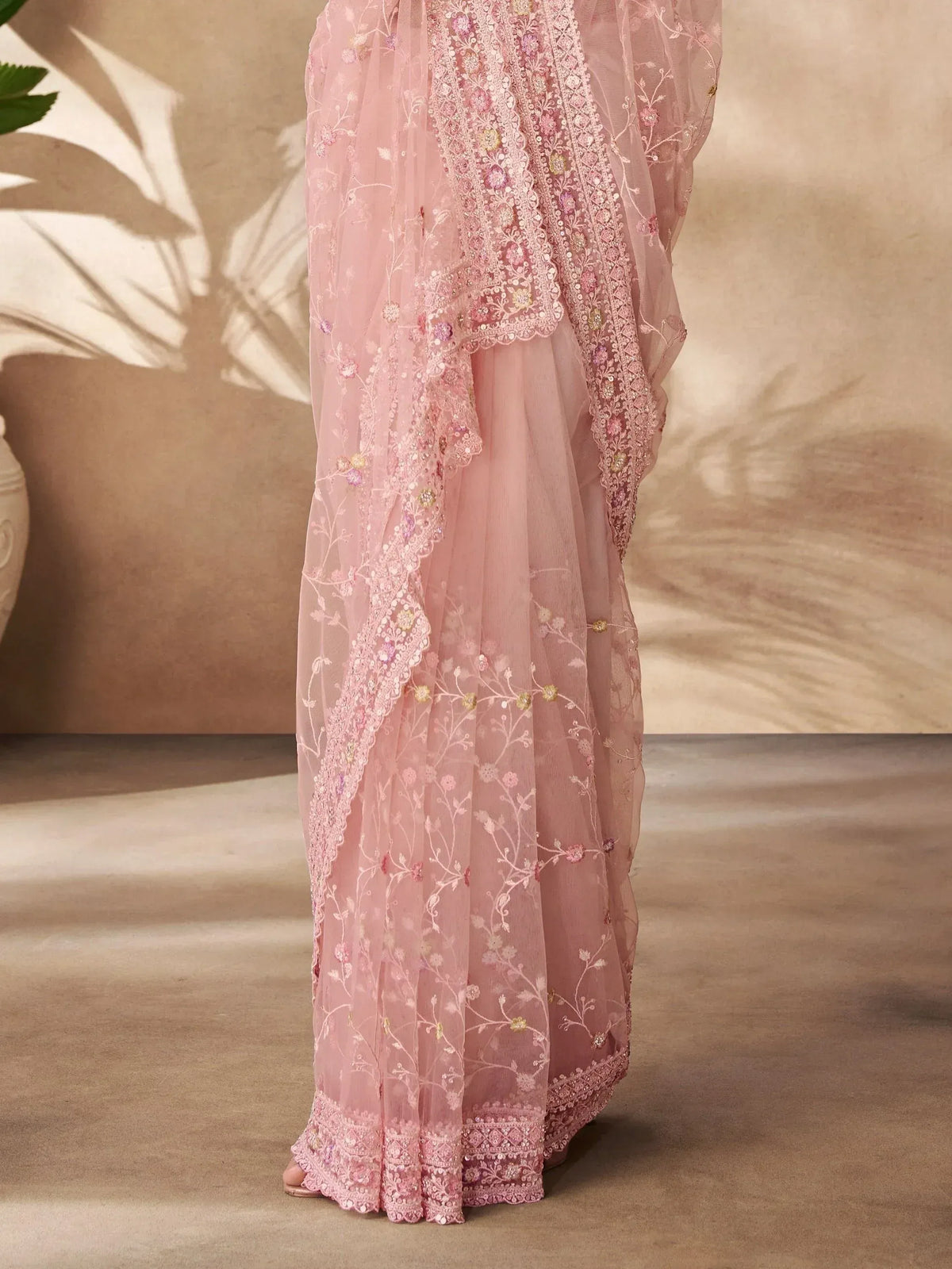 Pink embroidered ethnic gown with floral lace detailing, perfect for Indian festive occasions