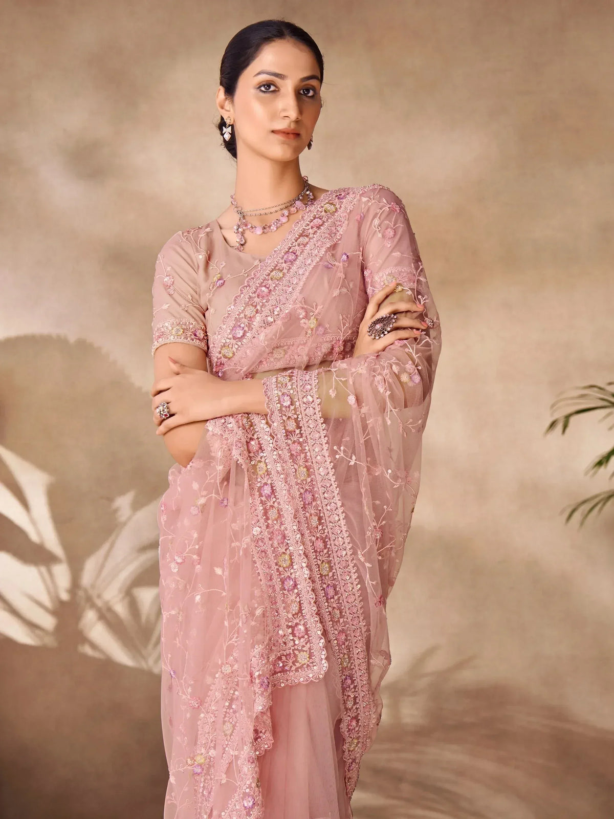 Elegant pink embroidered saree with floral detailing, perfect for Indian ethnic wear occasions.