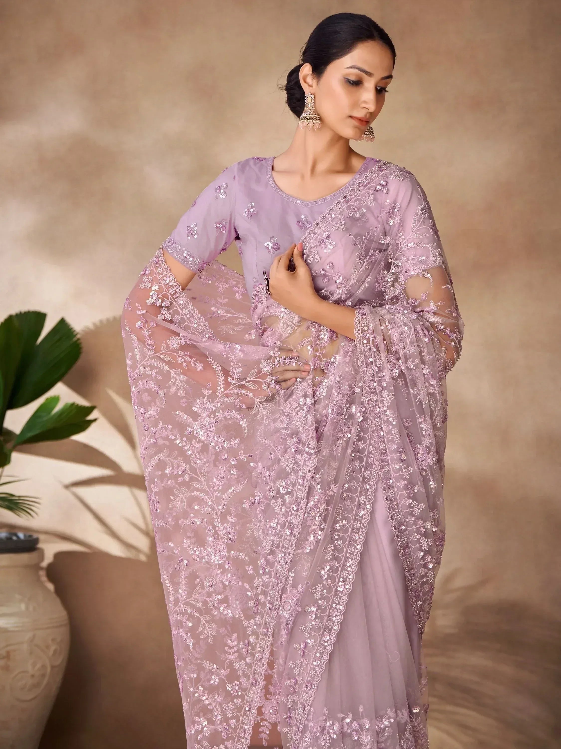 Lavender ethnic saree with floral sequin embroidery and sheer blouse, perfect for Indian weddings or parties.