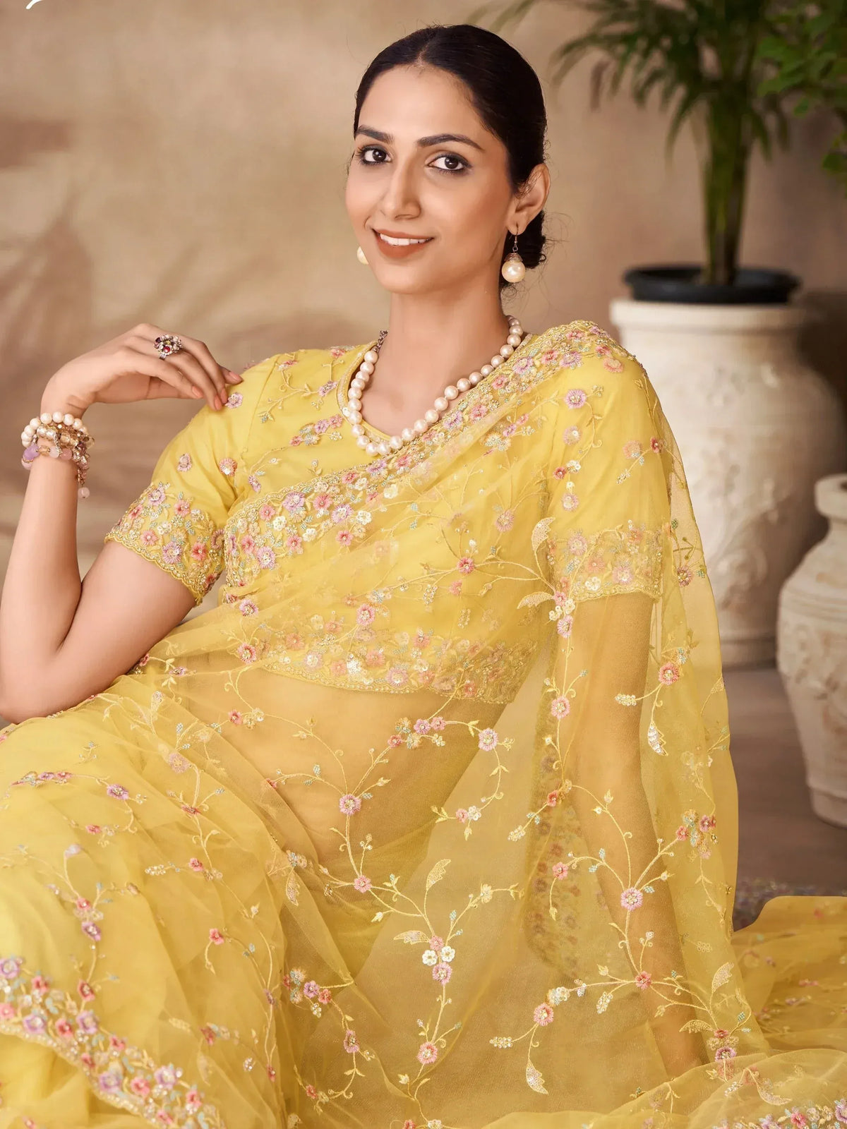 Yellow floral embroidered saree with pearl jewelry, Indian ethnic wear for women