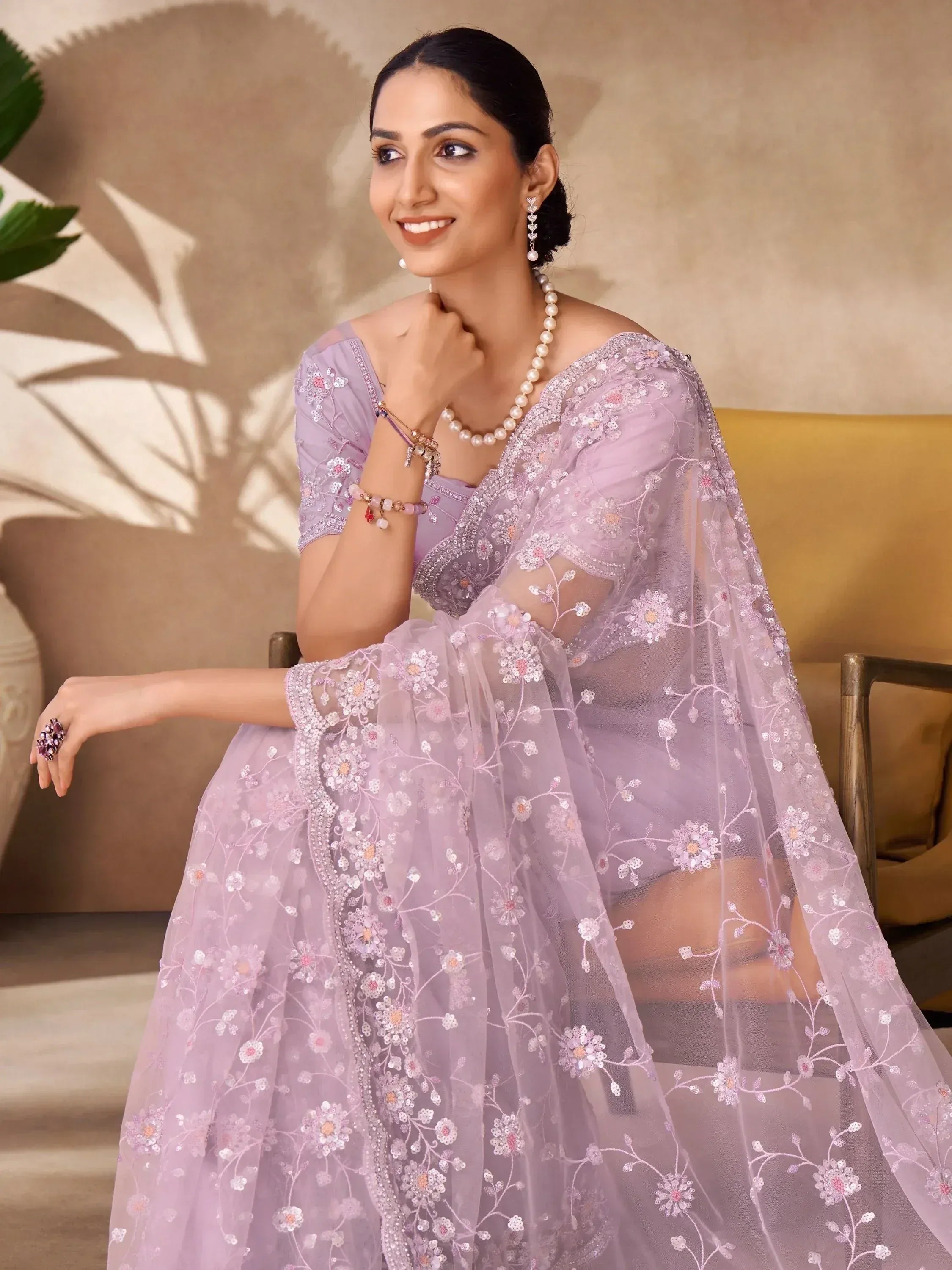 Lavender designer lehenga choli with floral embroidery and sheer dupatta, perfect for Indian ethnic wear occasions.