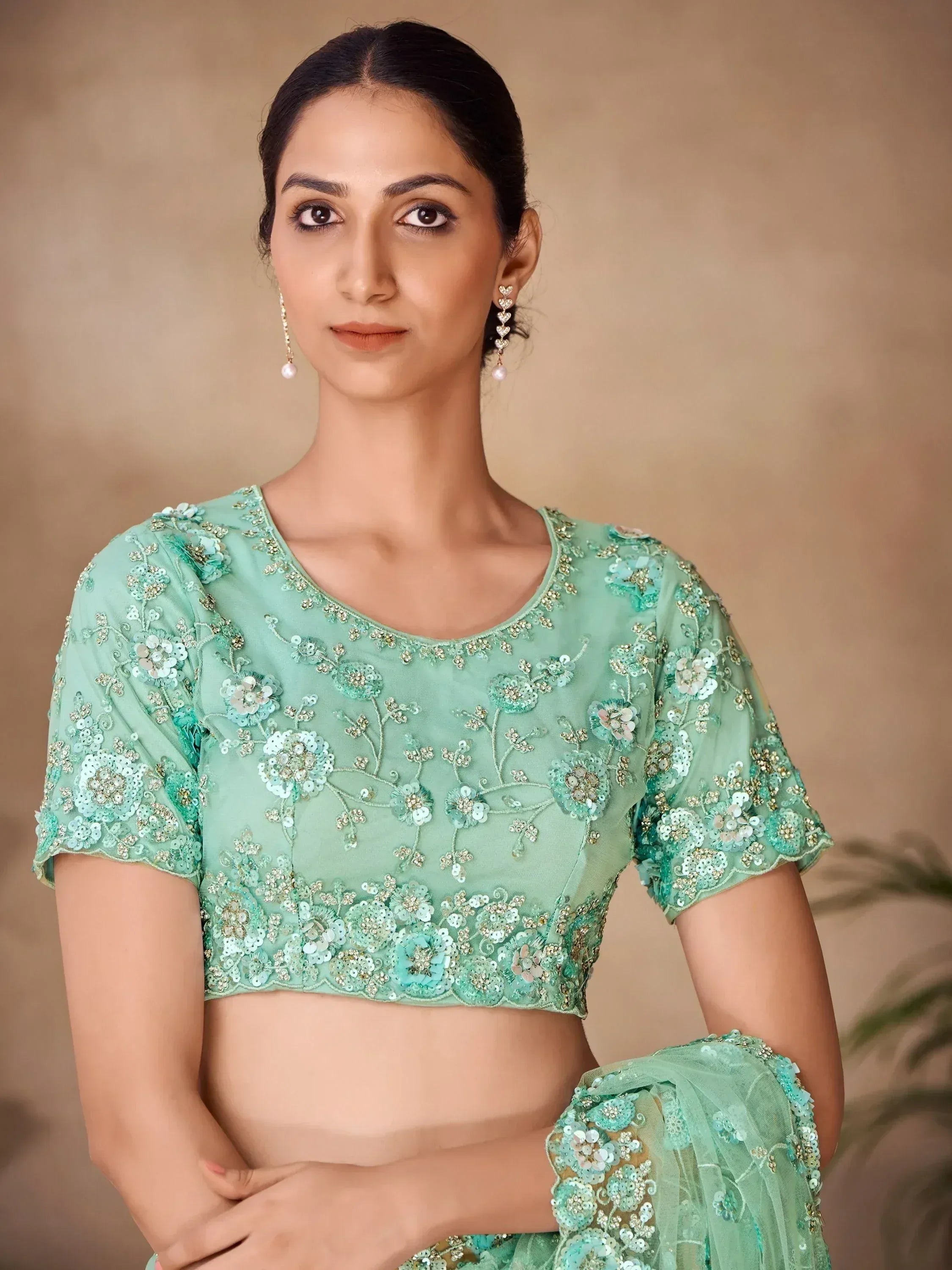 Mint green embroidered lehenga choli with floral sequin work, perfect for Indian ethnic wear occasions.