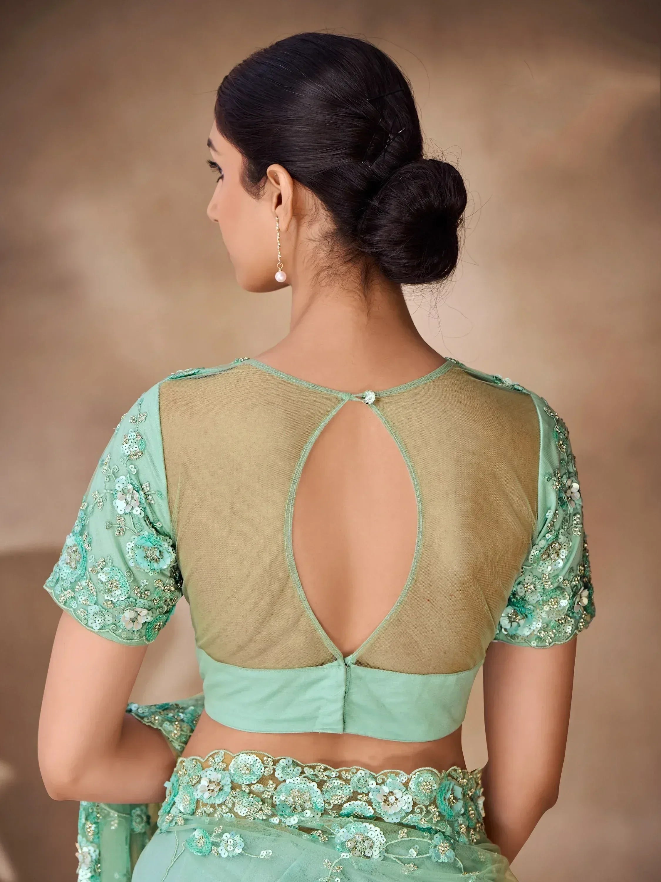 Mint green designer lehenga choli with floral sequin embroidery and sheer back blouse