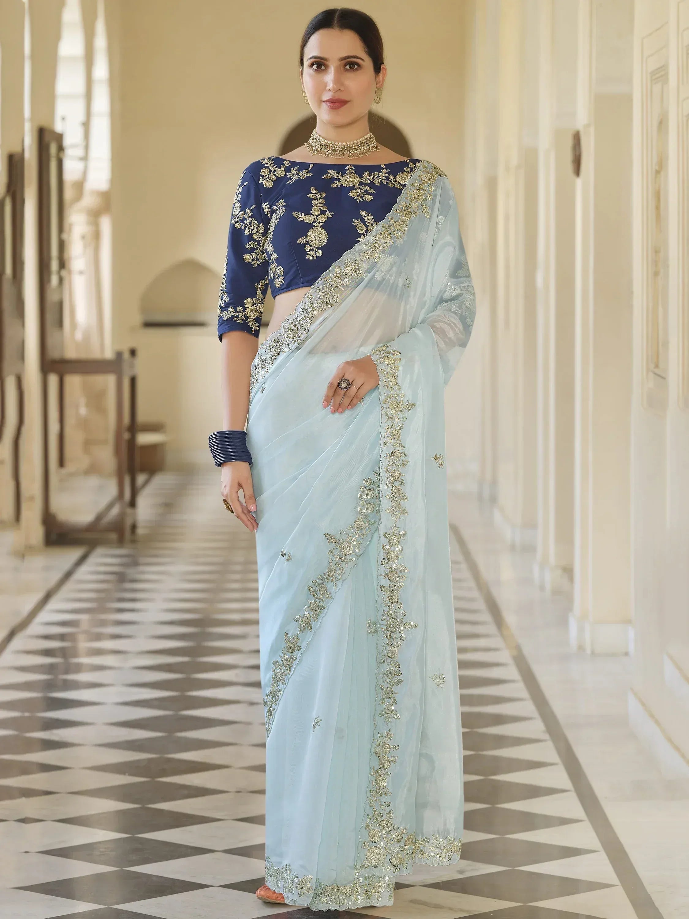 Light blue saree with gold embroidery and navy blue blouse, elegant Indian ethnic wear