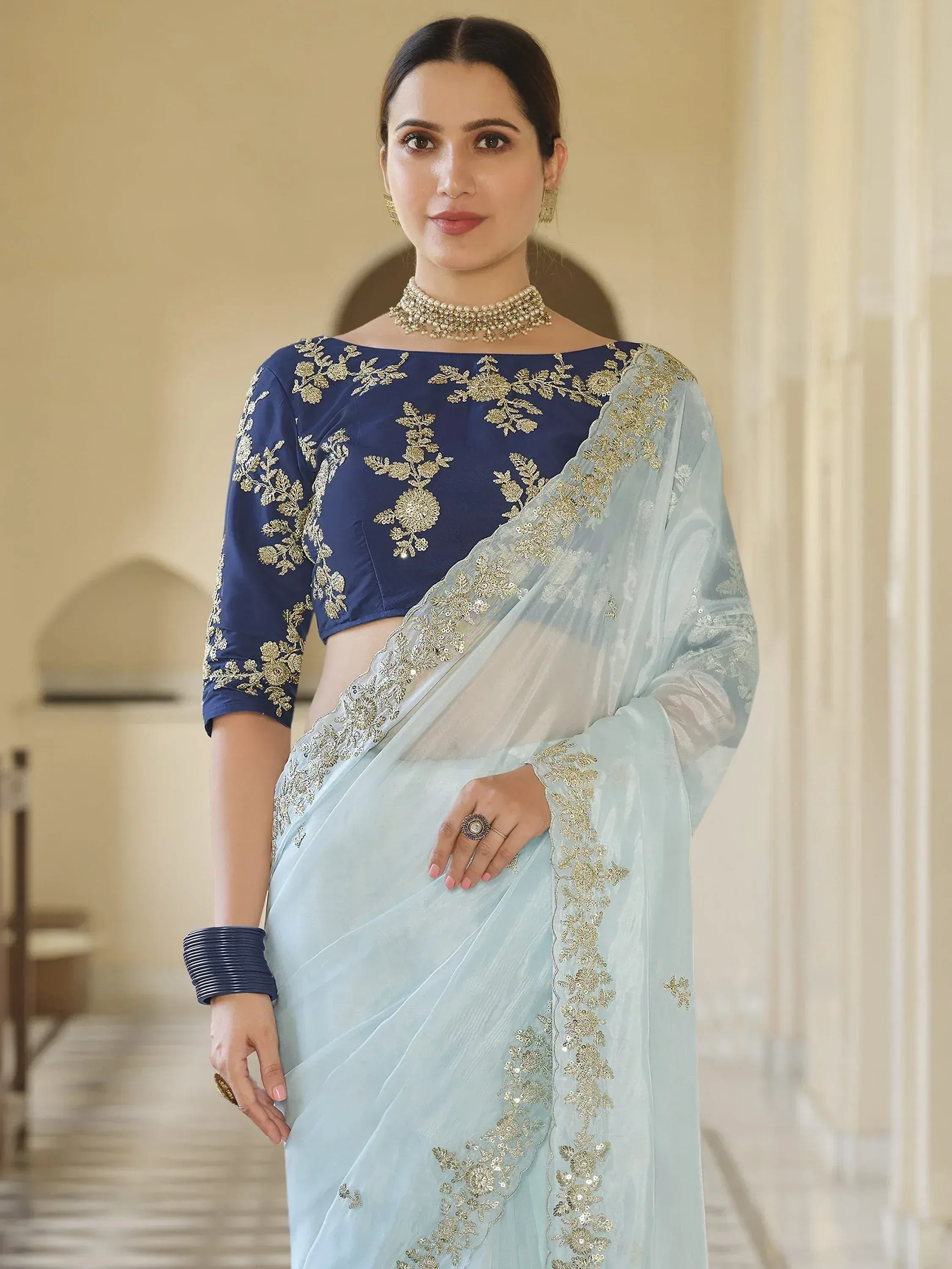 Light blue saree with gold embroidery paired with navy blue blouse, Indian ethnic wear